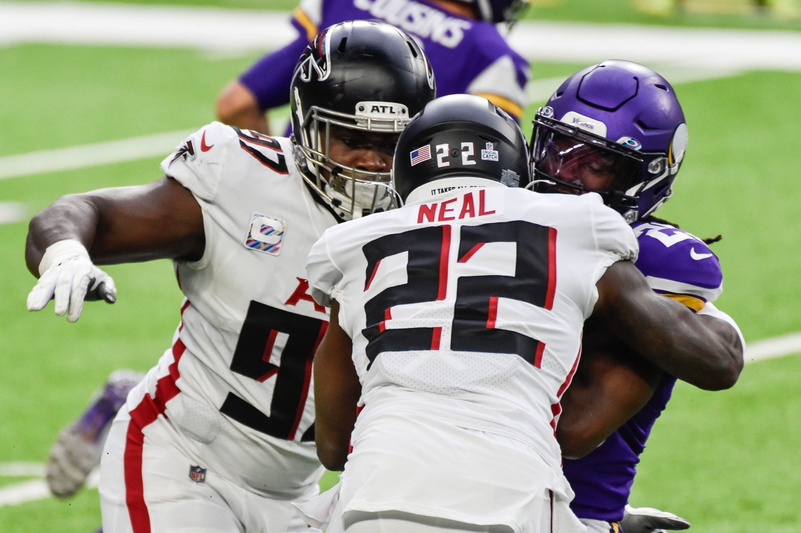 Oct 18, 2020; Minneapolis, Minnesota, USA; Atlanta Falcons strong safety Keanu Neal (22) and defensive tackle Grady Jarrett (97) tackle Minnesota Vikings running back Alexander Mattison (25) during the first quarter at U.S. Bank Stadium. Mandatory Credit: Jeffrey Becker-USA TODAY Sports