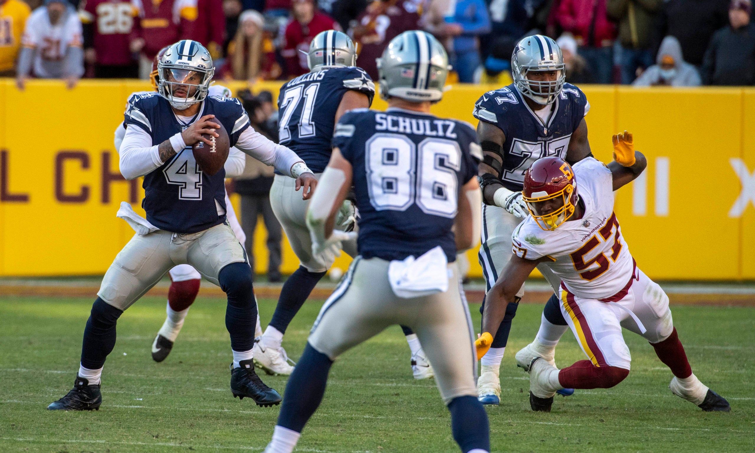 Dec 12, 2021; Landover, Maryland, USA; Dallas Cowboys quarterback Dak Prescott (4) scrambles against the Washington Football Team during the second half at FedExField. Mandatory Credit: Brad Mills-USA TODAY Sports