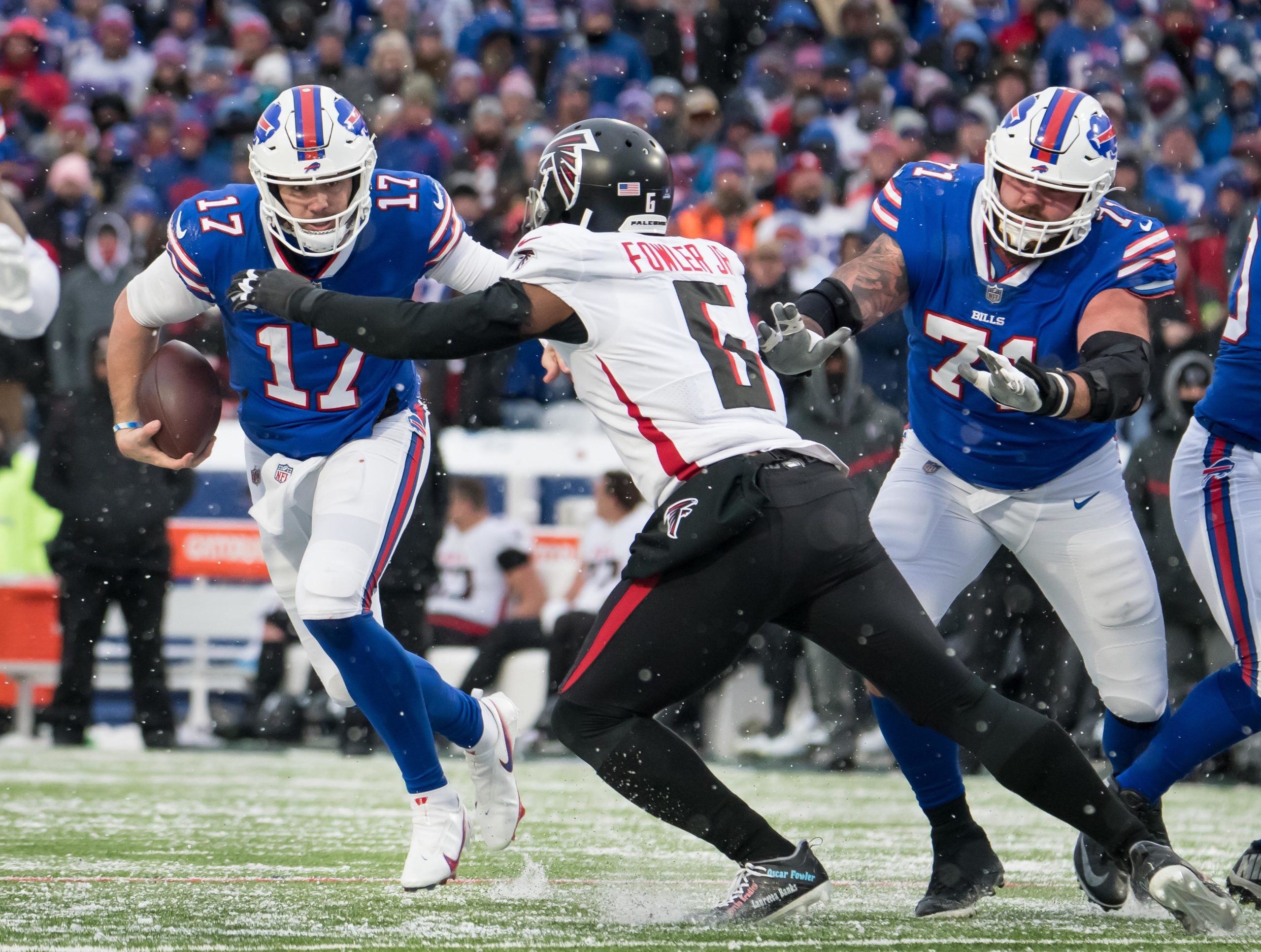 Jan 2, 2022; Orchard Park, New York, USA; Buffalo Bills quarterback Josh Allen (17) tries to avoid Atlanta Falcons outside linebacker Dante Fowler Jr. (6) as offensive tackle Ryan Bates (71) blocks in the third quarter at Highmark Stadium. Mandatory Credit: Mark Konezny-USA TODAY Sports