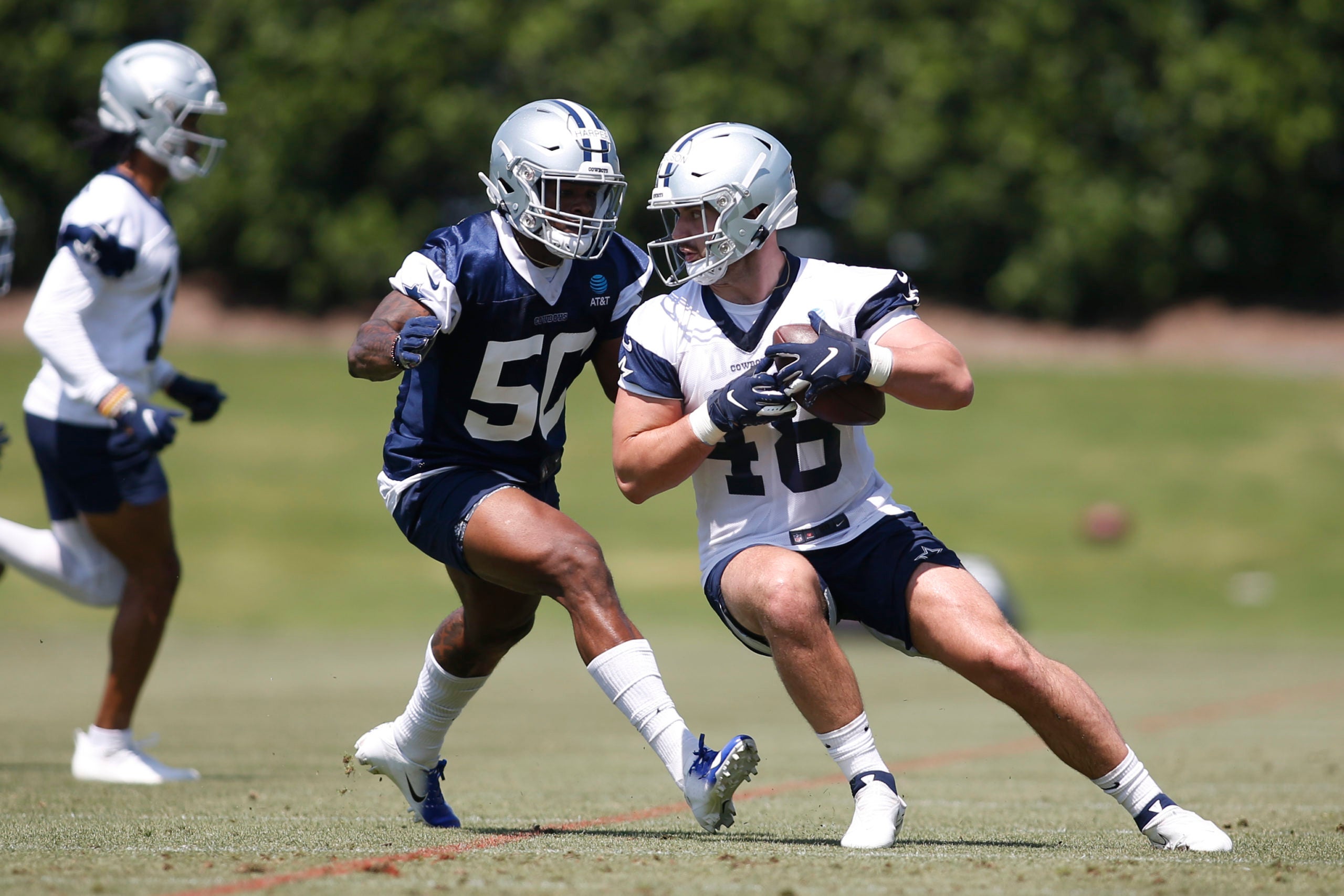May 14, 2022; Frisco, Texas, USA; Dallas Cowboys tight end Jake Ferguson (48) catches a pass against linebacker Devin Harper (50) during practice at the Ford Center at the Star Training Facility in Frisco, Texas.   Mandatory Credit: Tim Heitman-USA TODAY Sports