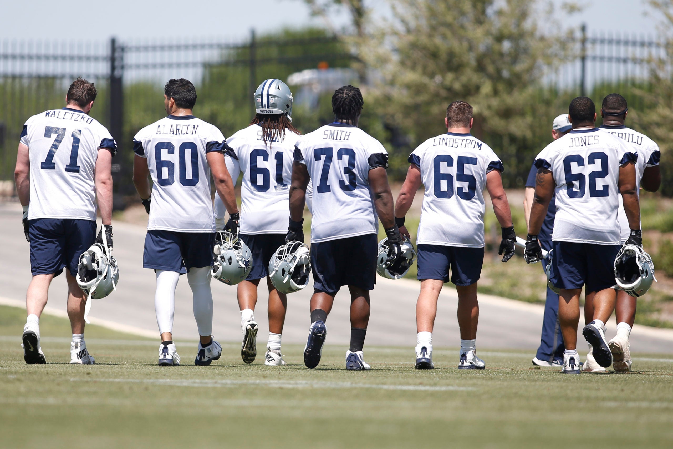 May 14, 2022; Frisco, Texas, USA; Dallas Cowboys offensive tackle Matt Waletzko (71) and guard Isaac Alaarcon (60) and offensive tackle Amon Simon (61) and offensive tackle Tyler Smith (73) and center Alec Lindstrom (65) and center Braylon Jones (62) walk on the field during practice at the Ford Center at the Star Training Facility in Frisco, Texas.   Mandatory Credit: Tim Heitman-USA TODAY Sports
