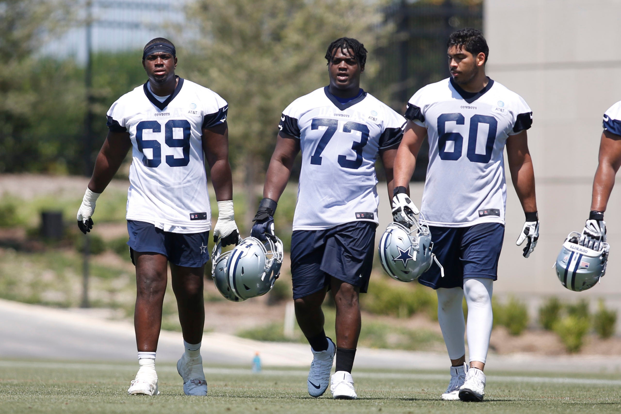 May 14, 2022; Frisco, Texas, USA; Dallas Cowboys offensive tackle Alex Akingbulu (69) and offensive tackle Tyler Smith (73) and guard Isaac Alaarcon (60) walk on the field during practice at the Ford Center at the Star Training Facility in Frisco, Texas.   Mandatory Credit: Tim Heitman-USA TODAY Sports