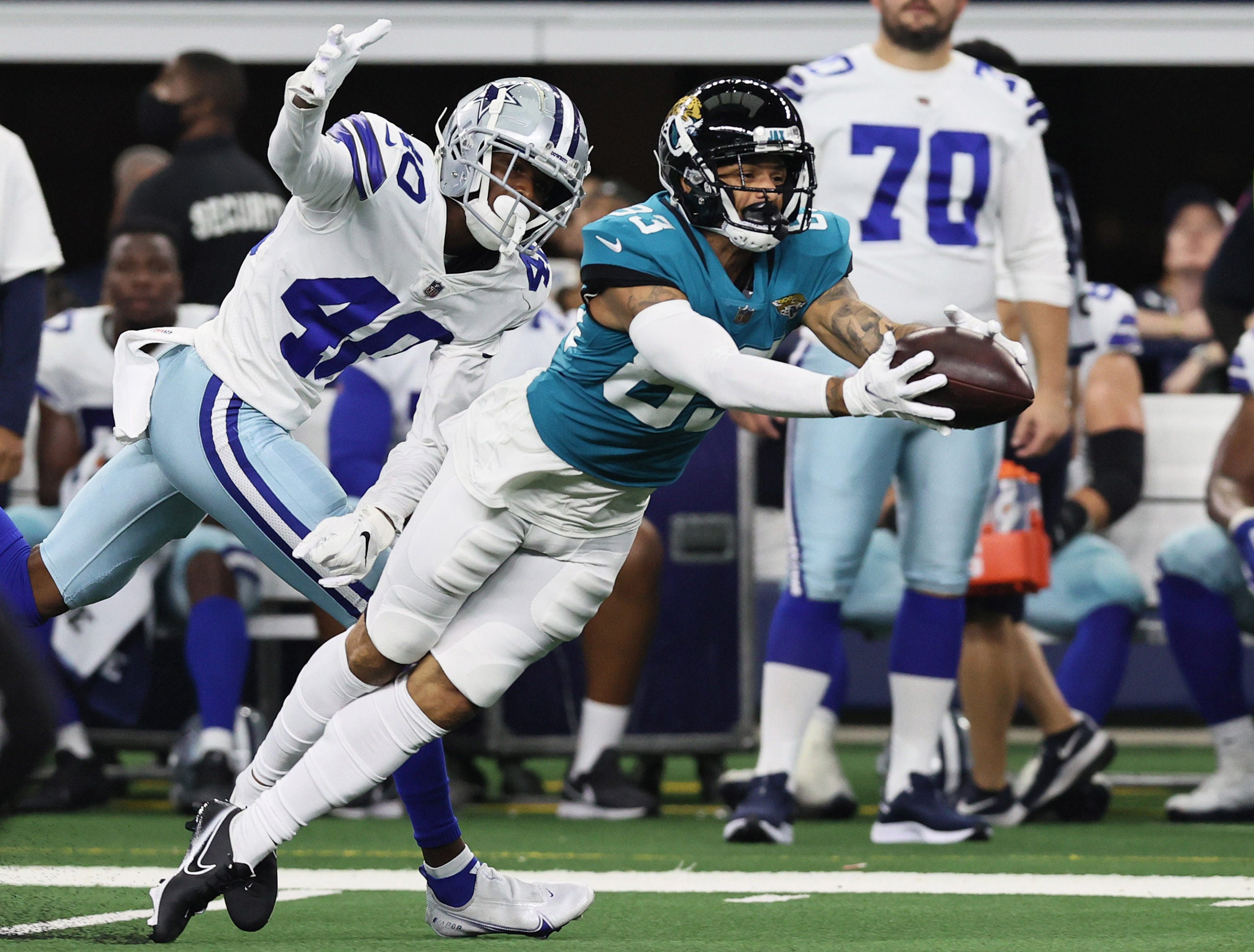 Aug 29, 2021; Arlington, Texas, USA; Jacksonville Jaguars receiverDevin Smith (83) dives for the ball against Dallas Cowboys cornerback Nahshon Wright (40) at AT&T Stadium. Mandatory Credit: Matthew Emmons-USA TODAY Sports