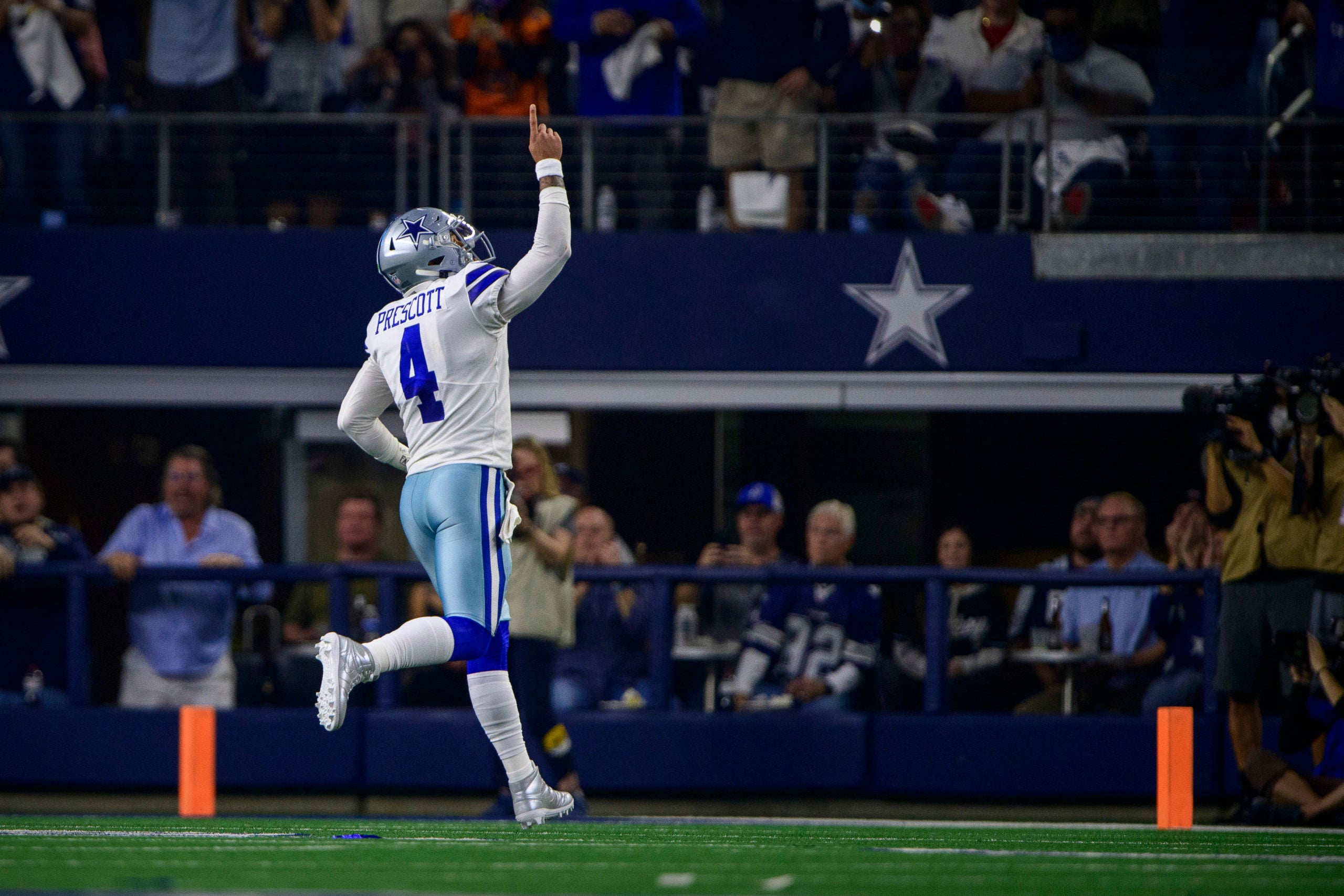 Dec 26, 2021; Arlington, Texas, USA; Dallas Cowboys quarterback Dak Prescott (4) celebrates throwing a touchdown against the Washington Football Team during the first quarter at AT&T Stadium. Mandatory Credit: Jerome Miron-USA TODAY Sports