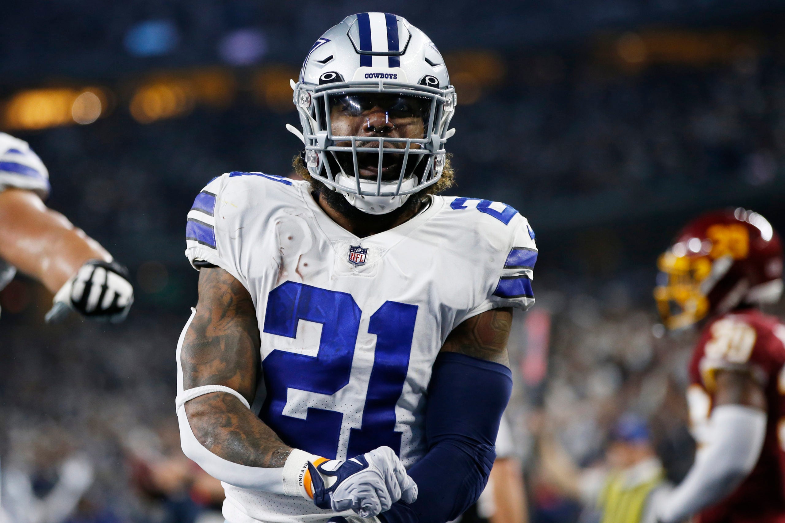 Dec 26, 2021; Arlington, Texas, USA; Dallas Cowboys running back Ezekiel Elliott (21) celebrates scoring a touchdown in the second quarter against the Washington Football Team at AT&T Stadium. Mandatory Credit: Tim Heitman-USA TODAY Sports