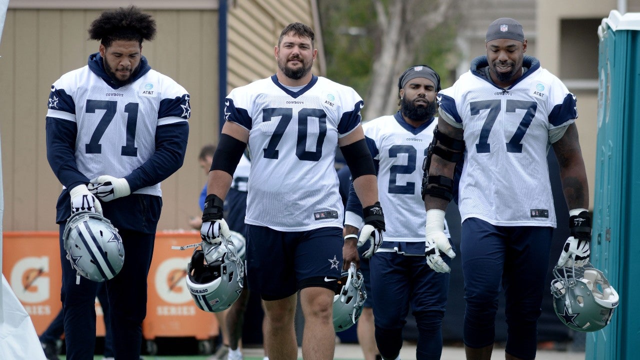 Offensive tackle La'el Collins (left to right), offensive guard Zack Martin, running back Ezekiel Elliott and offensive tackle Tyron Smith head out to the field during the Dallas Cowboys' first full day of training camp at the River Ridge Playing Fields in Oxnard on Saturday, July 24, 2021. Cowboys Training Camp 24