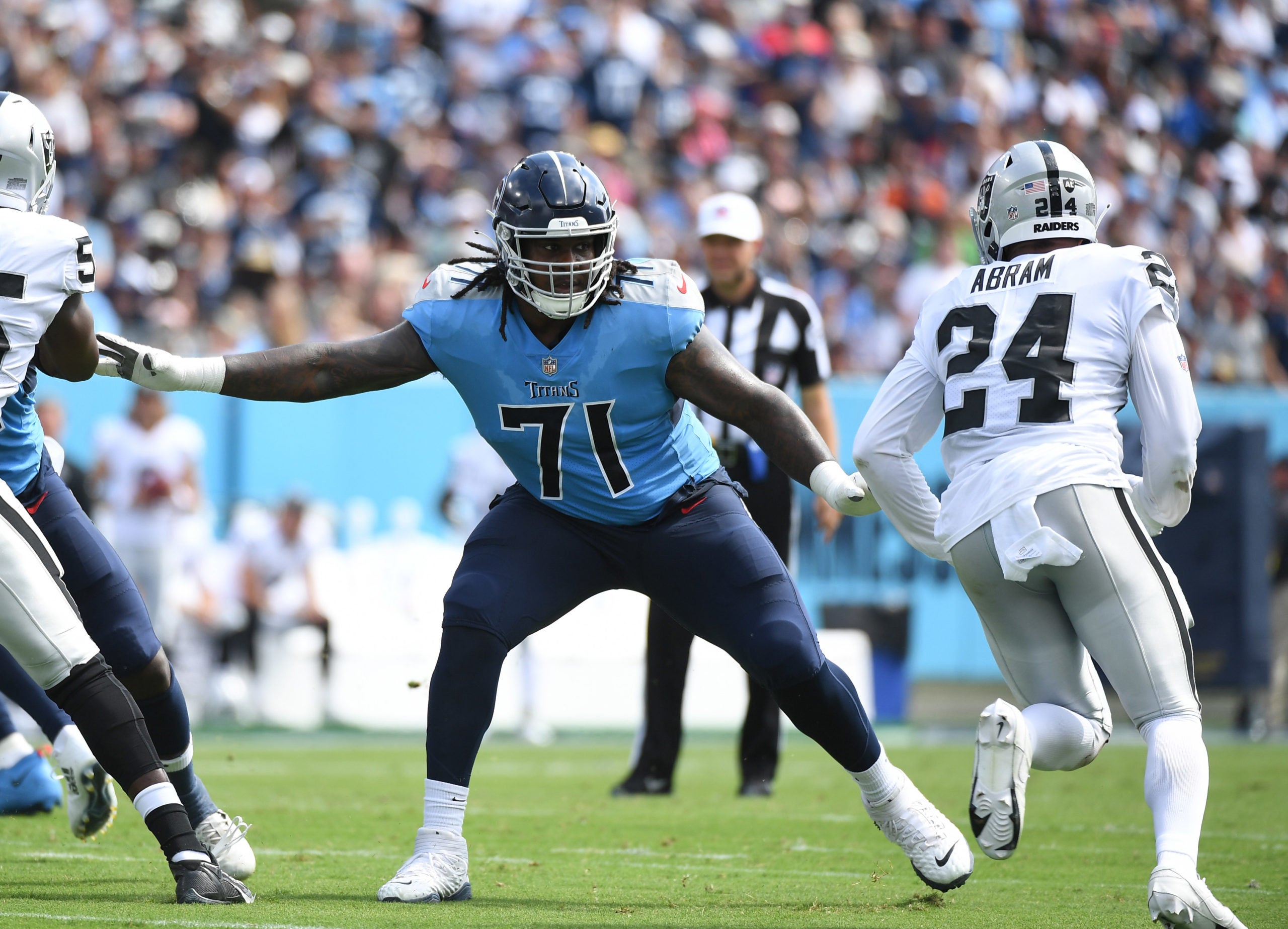 Sep 25, 2022; Nashville, Tennessee, USA; Tennessee Titans guard Dennis Daley (71) blocks against Las Vegas Raiders safety Johnathan Abram (24) during the first half at Nissan Stadium. Mandatory Credit: Christopher Hanewinckel-USA TODAY Sports