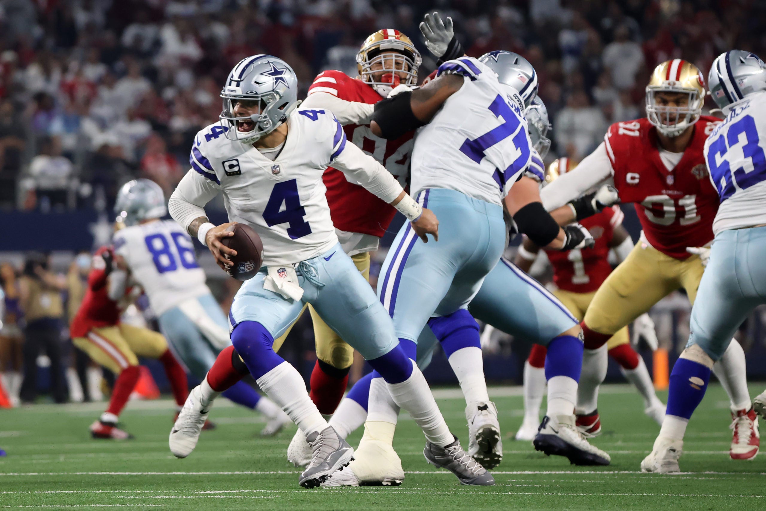 Jan 16, 2022; Arlington, Texas, USA; Dallas Cowboys quarterback Dak Prescott (4) scrambles with the ball against the San Francisco 49ers during the second half of the NFC Wild Card playoff football game at AT&T Stadium. Mandatory Credit: Kevin Jairaj-USA TODAY Sports