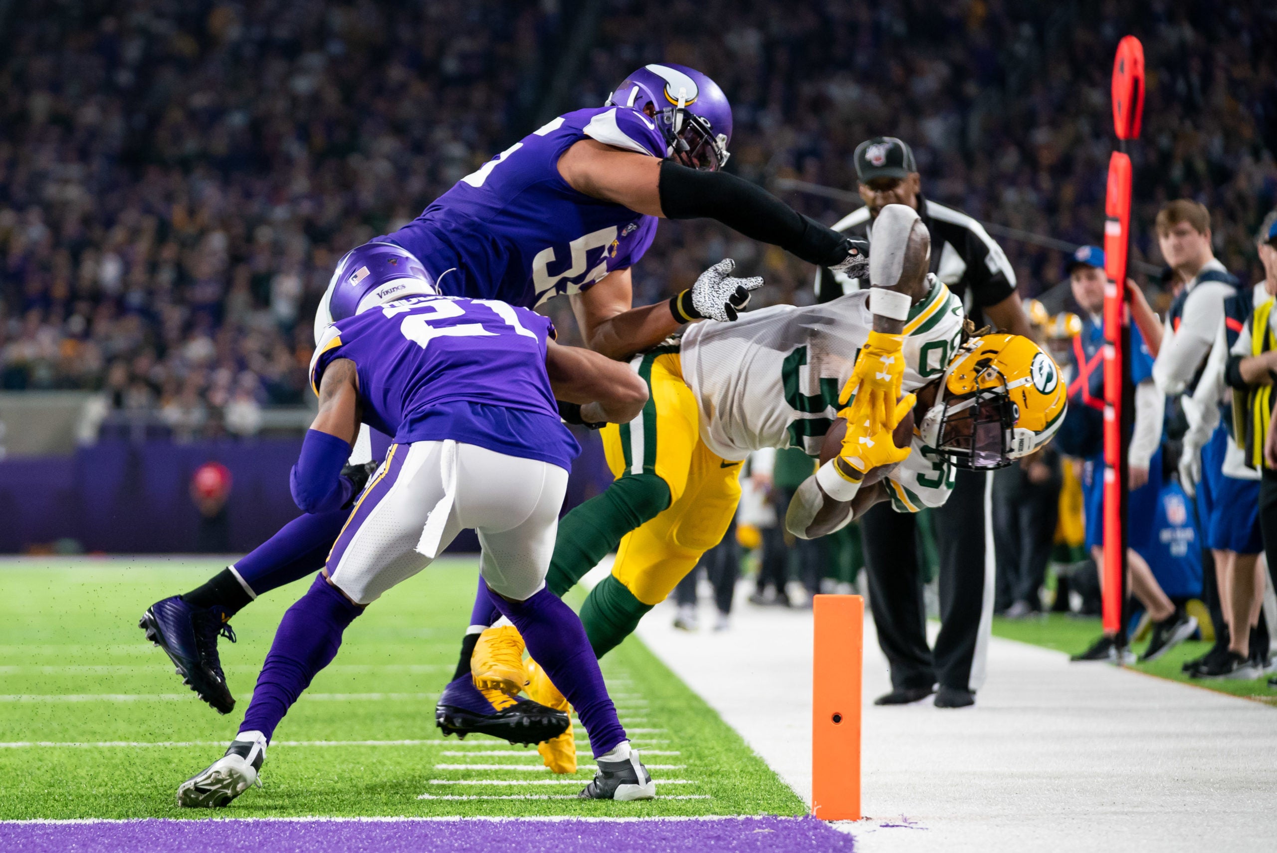 Dec 23, 2019; Minneapolis, Minnesota, USA;  Green Bay Packers running back Jamaal Williams (30) is forced out of bounds in the second quarter by Minnesota Vikings linebacker Anthony Barr (55) at U.S. Bank Stadium. Mandatory Credit: Brad Rempel-USA TODAY Sports