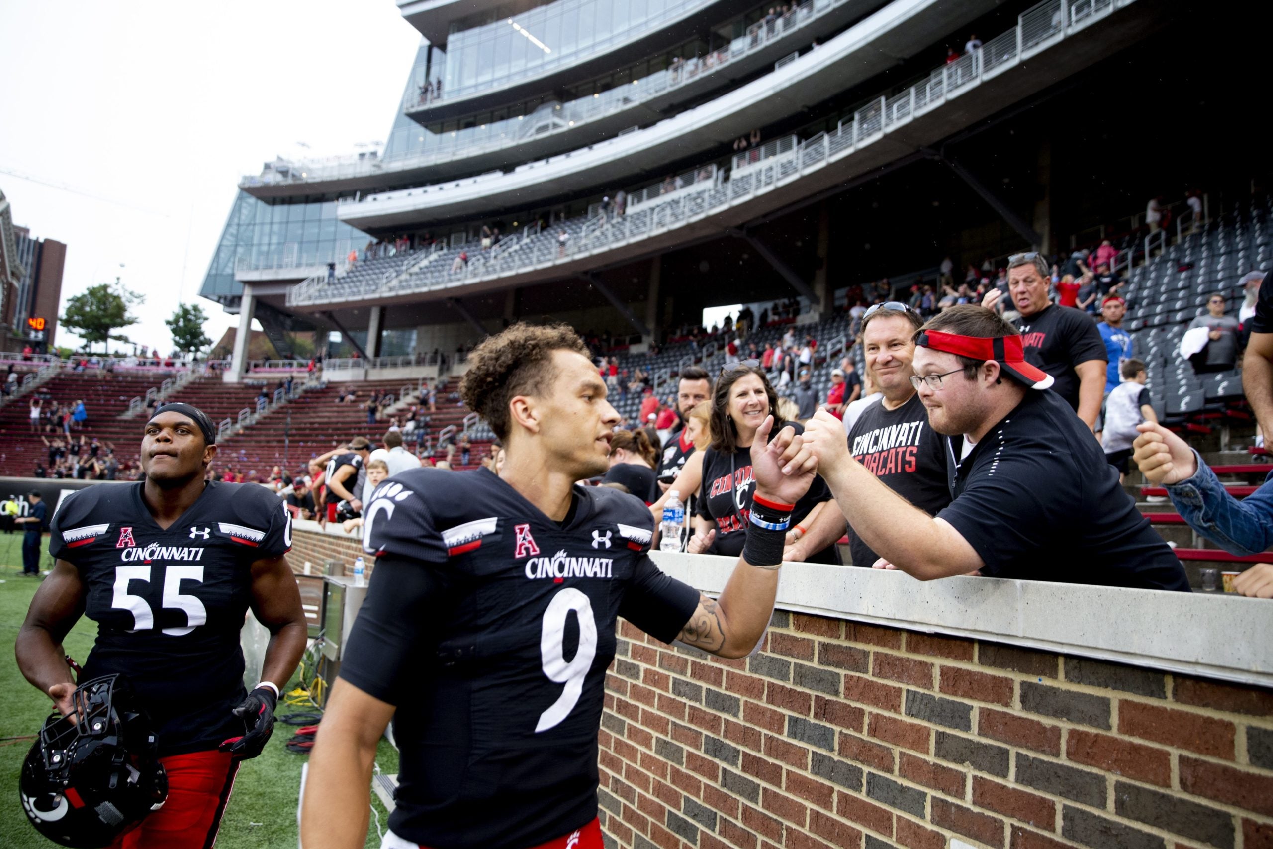Cincinnati Bearcats quarterback Desmond Ridder (9) fist bumps a fan after the NCAA football game on Saturday, Sept. 4, 2021, at Nippert Stadium in Cincinnati. Cincinnati Bearcats Miami Redhawks
