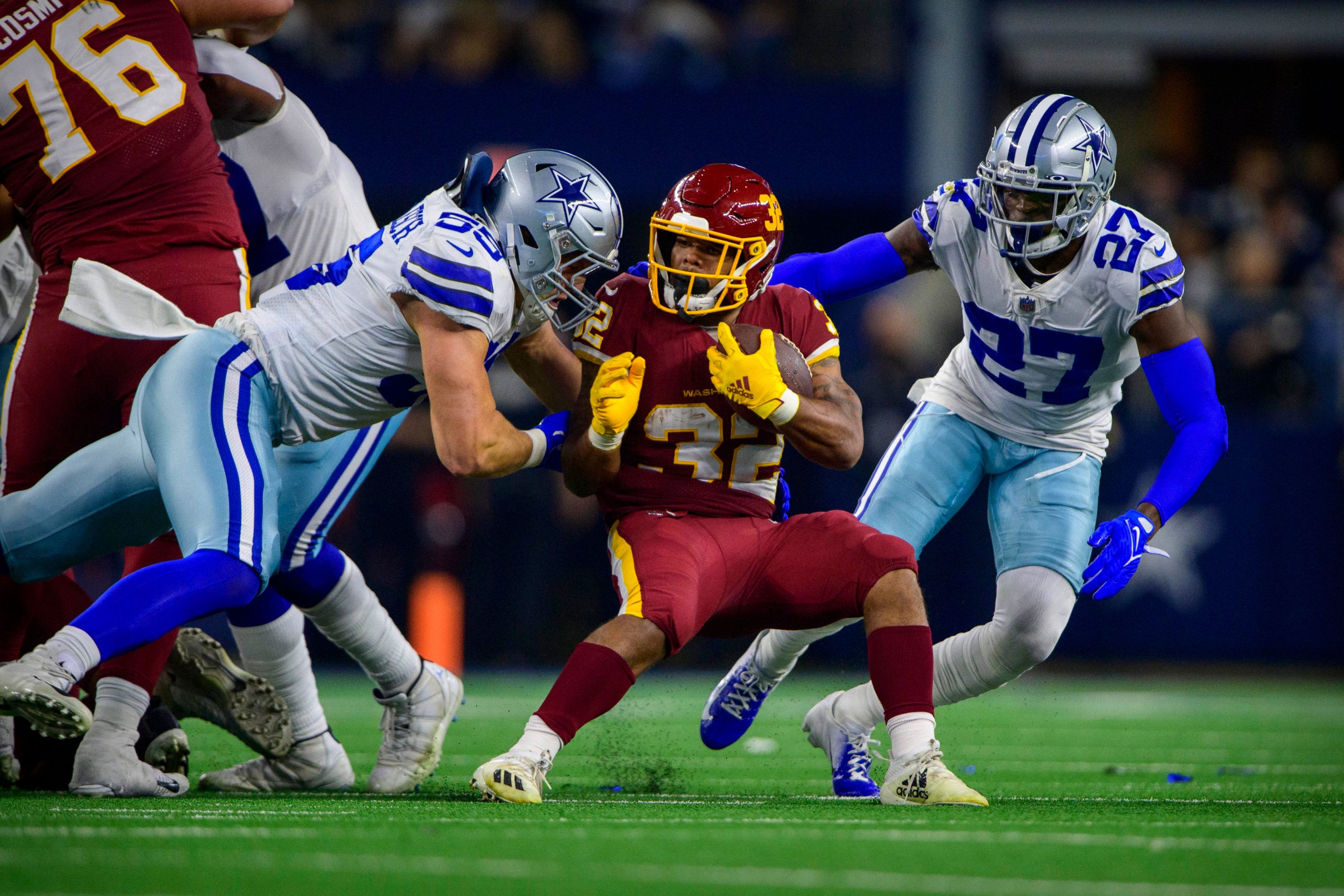 Dec 26, 2021; Arlington, Texas, USA; Washington Football Team running back Jaret Patterson (32) is tackled by Dallas Cowboys outside linebacker Leighton Vander Esch (55) and safety Jayron Kearse (27) during the second half at AT&T Stadium. Mandatory Credit: Jerome Miron-USA TODAY Sports