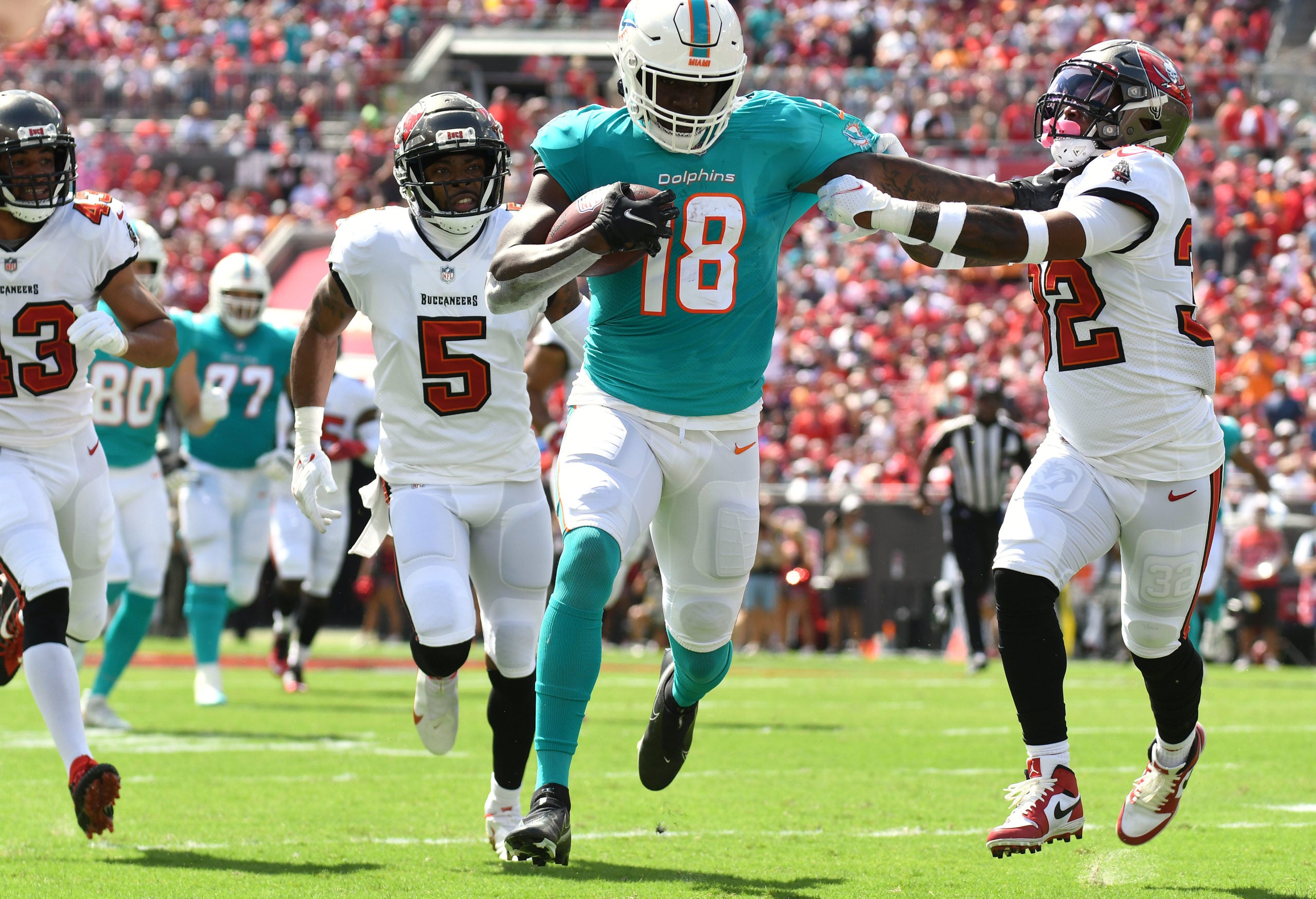 Oct 10, 2021; Tampa, Florida, USA;  Miami Dolphins wide receiver Preston Williams (18) attempts to get past Tampa Bay Buccaneers defensive back Mike Edwards (32) in the first half at Raymond James Stadium. Mandatory Credit: Jonathan Dyer-USA TODAY Sports