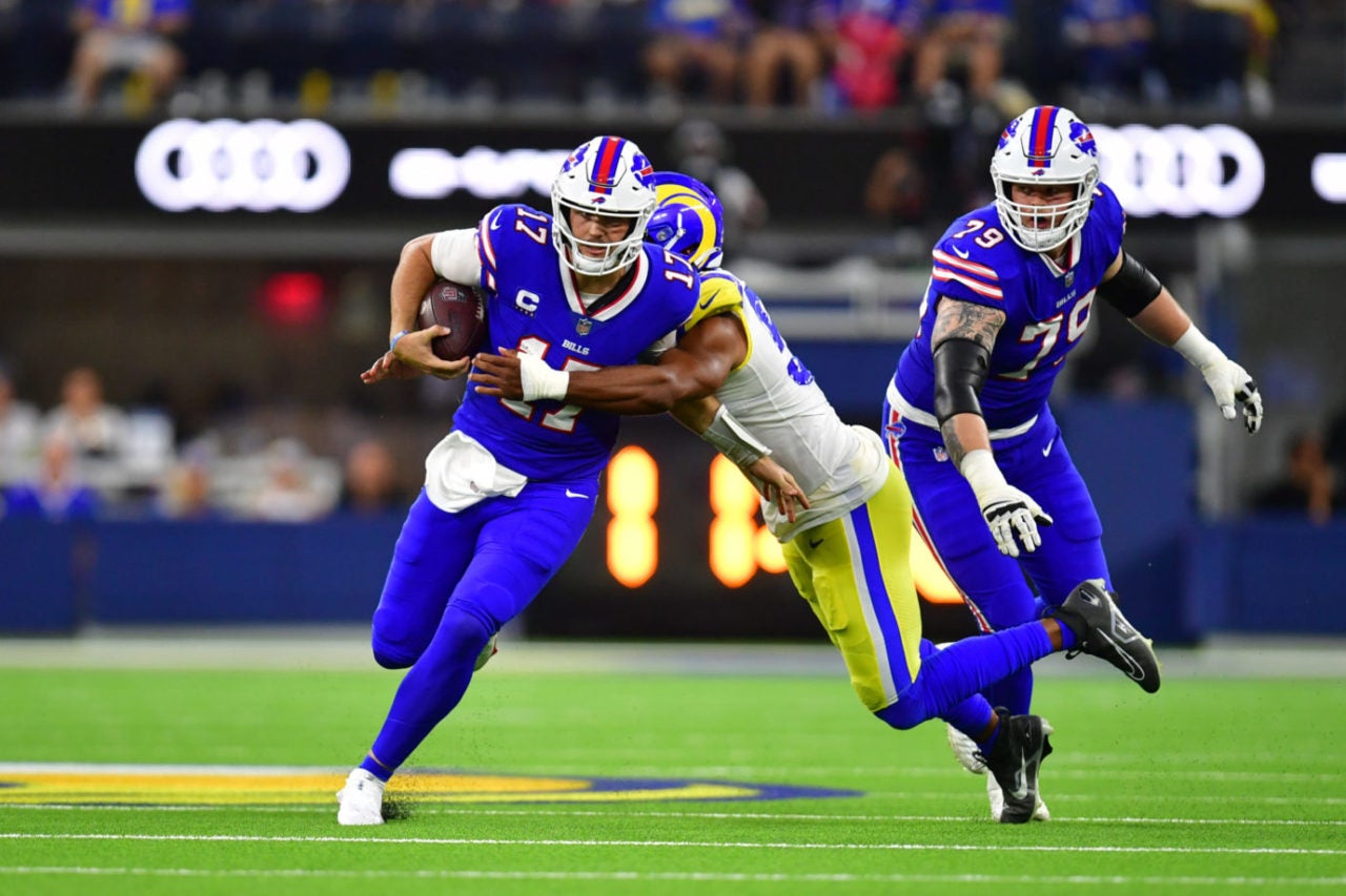 Sep 8, 2022; Inglewood, California, USA; Buffalo Bills quarterback Josh Allen (17) is tackled by Los Angeles Rams linebacker Justin Hollins (58) in the third quarter at SoFi Stadium. Mandatory Credit: Gary A. Vasquez-USA TODAY Sports