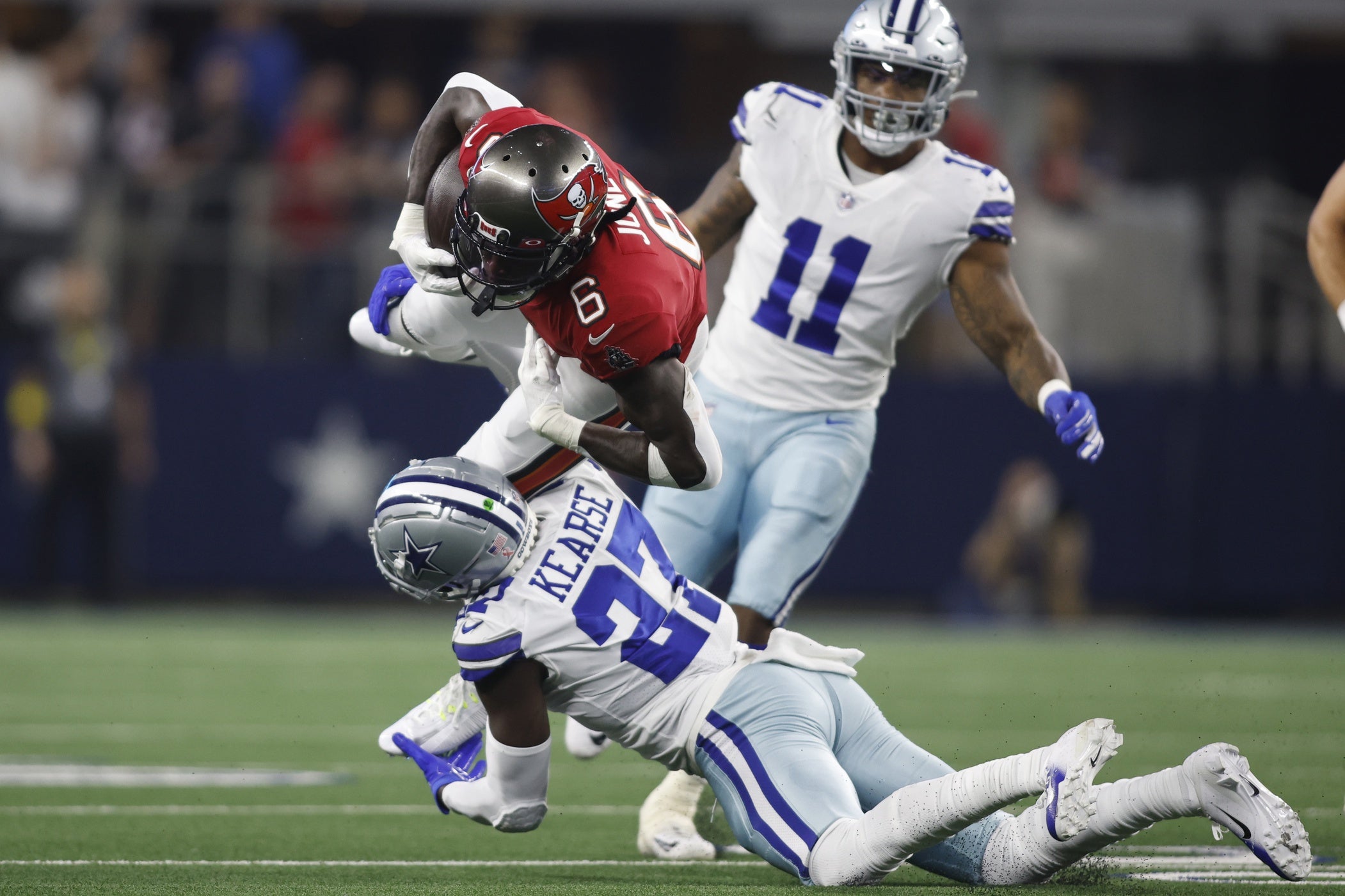 Sep 11, 2022; Arlington, Texas, USA; Tampa Bay Buccaneers wide receiver Julio Jones (6) is tackled by Dallas Cowboys safety Jayron Kearse (27) in the second quarter at AT&T Stadium. Mandatory Credit: Tim Heitman-USA TODAY Sports