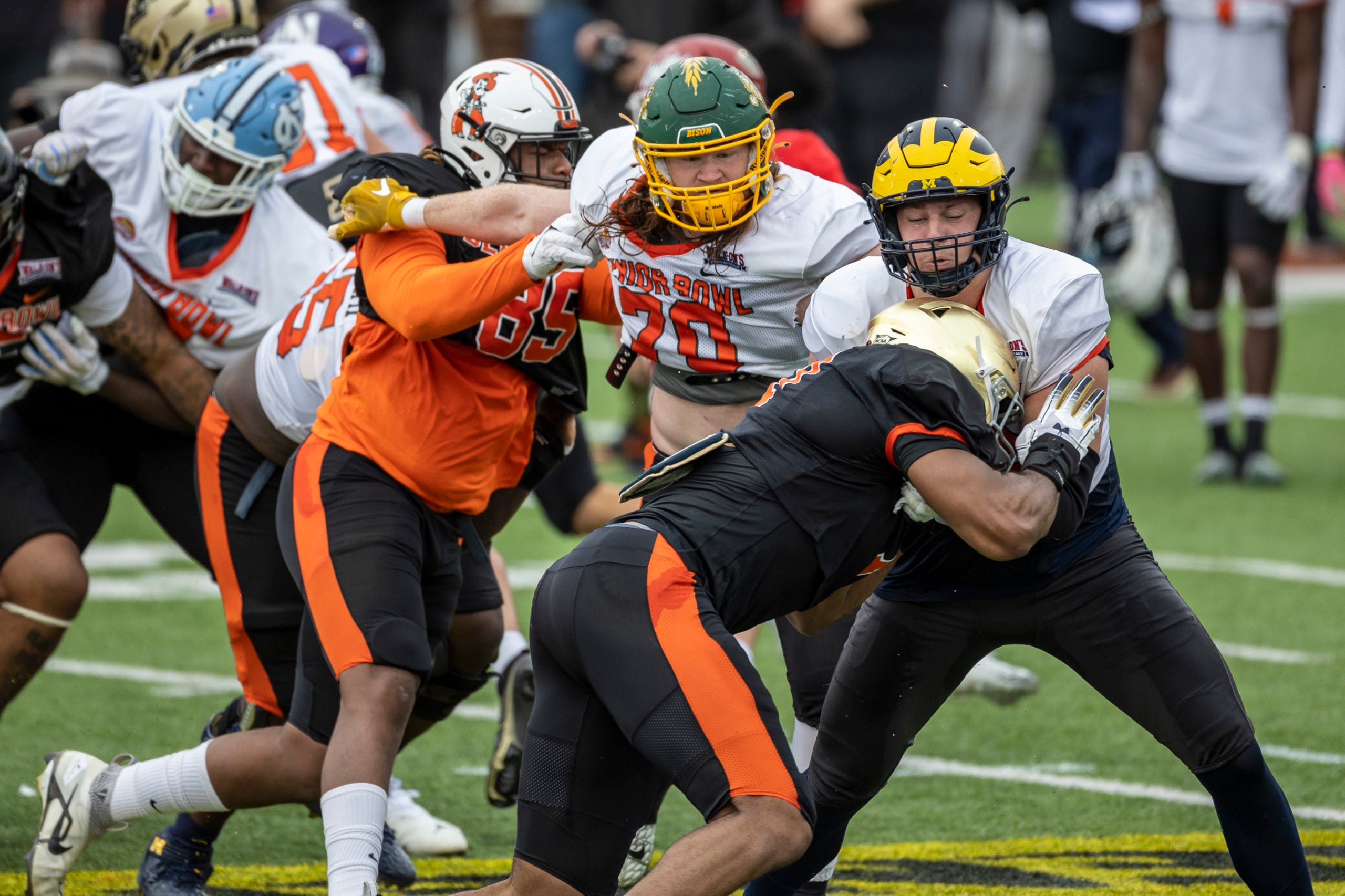 Feb 1, 2023; Mobile, AL, USA; National offensive lineman Cody Mauch of North Dakota State (70) looks to help National offensive lineman Ryan Hayes of Michigan (76) block National defensive lineman Keion White of Georgia Tech (6) during the second day of Senior Bowl week at Hancock Whitney Stadium in Mobile. Mandatory Credit: Vasha Hunt-USA TODAY Sports