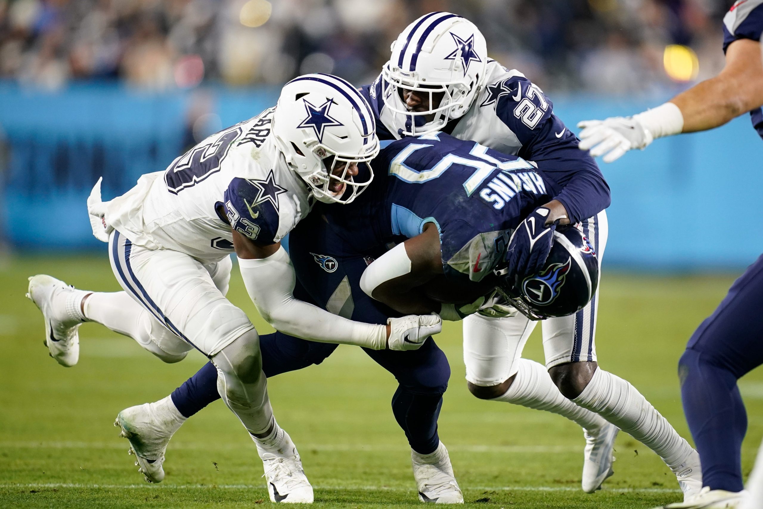 Tennessee Titans running back Hassan Haskins (25) is brought down by Dallas Cowboys linebacker Damone Clark (33) and safety Jayron Kearse (27) during the second quarter at Nissan Stadium Thursday, Dec. 29, 2022, in Nashville, Tenn. Nfl Dallas Cowboys At Tennessee Titans