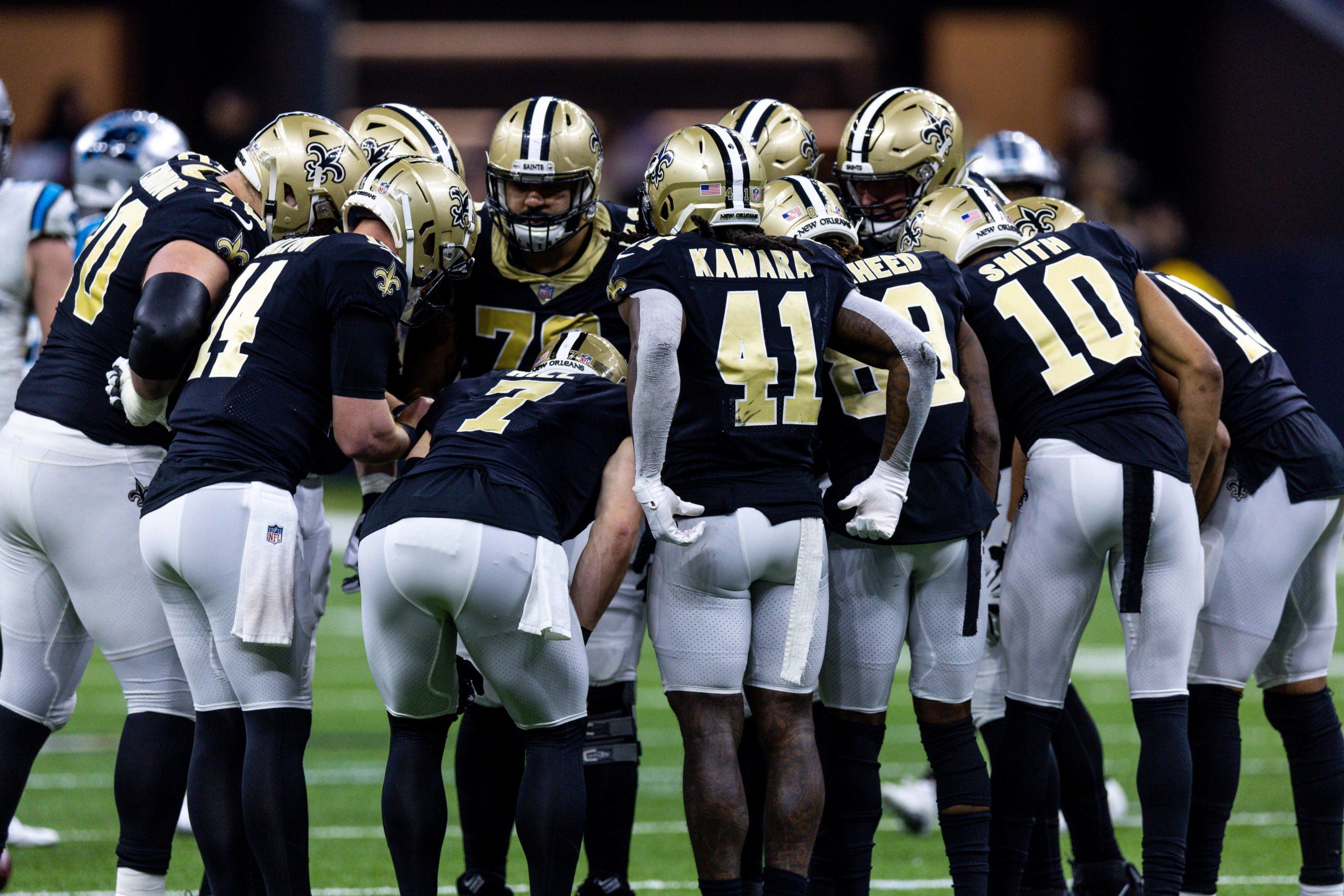 Jan 8, 2023; New Orleans, Louisiana, USA;  New Orleans Saints tight end Taysom Hill (7) calls a play in the huddle against the Carolina Panthers during the second half at Caesars Superdome. Mandatory Credit: Stephen Lew-USA TODAY Sports