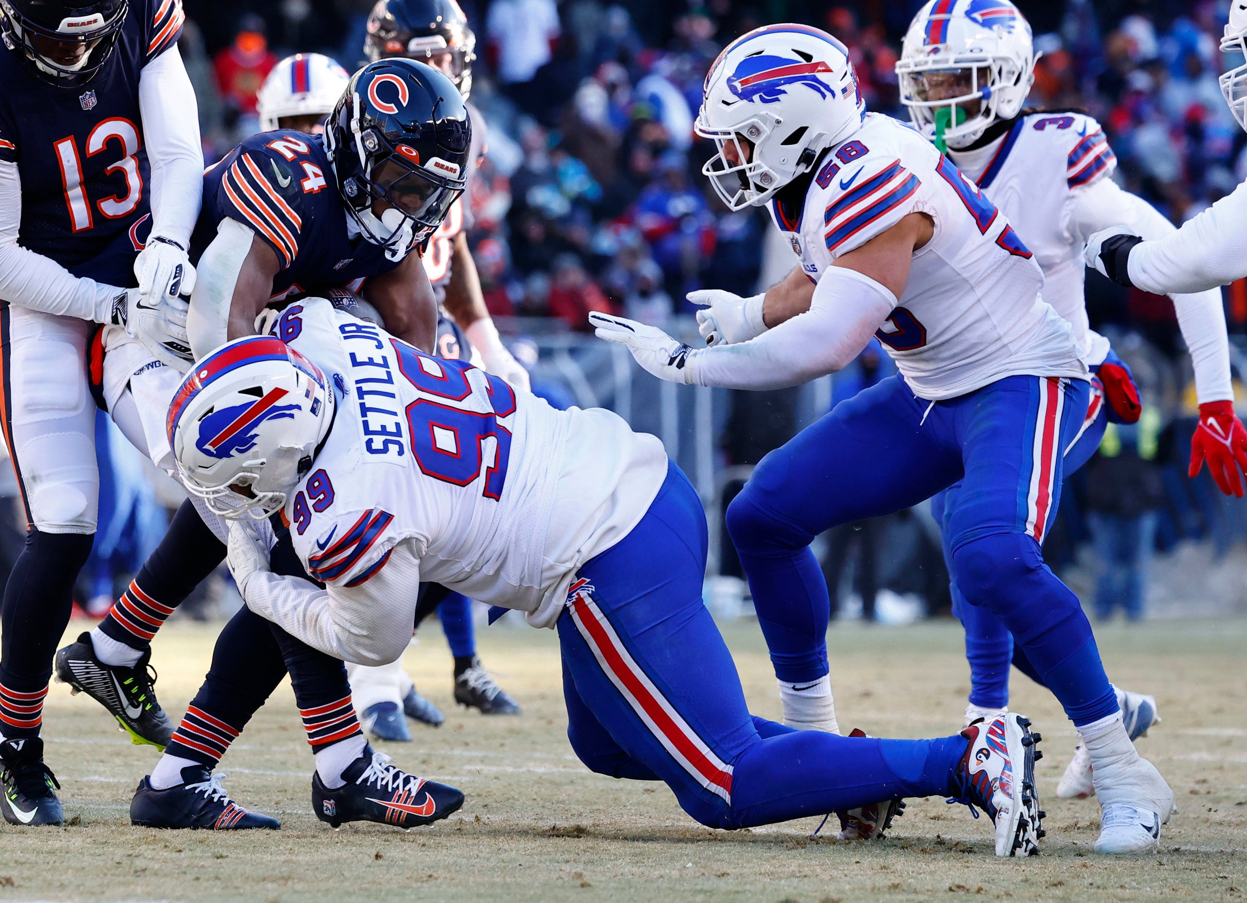 Dec 24, 2022; Chicago, Illinois, USA; Buffalo Bills defensive tackle Tim Settle (99) makes a tackle on Chicago Bears running back Khalil Herbert (24) during the second half at Soldier Field. Mandatory Credit: Mike Dinovo-USA TODAY Sports