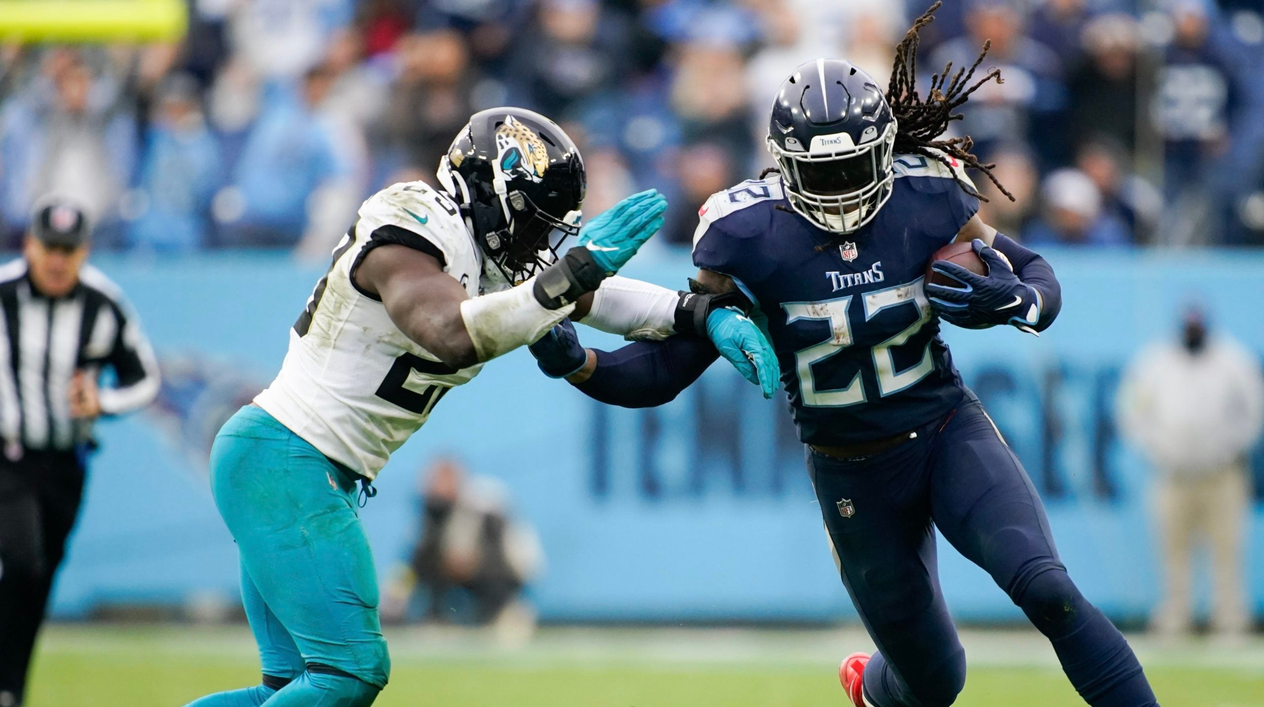 Dec 11, 2022; Nashville, Tennessee, USA; Tennessee Titans running back Derrick Henry (22) is tackled by Jacksonville Jaguars linebacker Foyesade Oluokun (23) during the fourth quarter at Nissan Stadium. Mandatory Credit: Andrew Nelles/The Tennessean-USA TODAY Sports