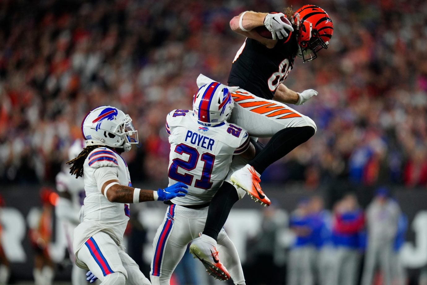 Cincinnati Bengals tight end Hayden Hurst (88) is wrapped up and tackled by Buffalo Bills safety Jordan Poyer (21) and safety Damar Hamlin (3) on a reception in the first quarter of the NFL Week 17 game between the Cincinnati Bengals and the Buffalo Bills at Paycor Stadium in Downtown Cincinnati on Monday, Jan. 2, 2023. The game was suspended with suspended in the first quarter after Buffalo Bills safety Damar Hamlin (3) was taken away in an ambulance following a play. Buffalo Bills At Cincinnati Bengals Week 17