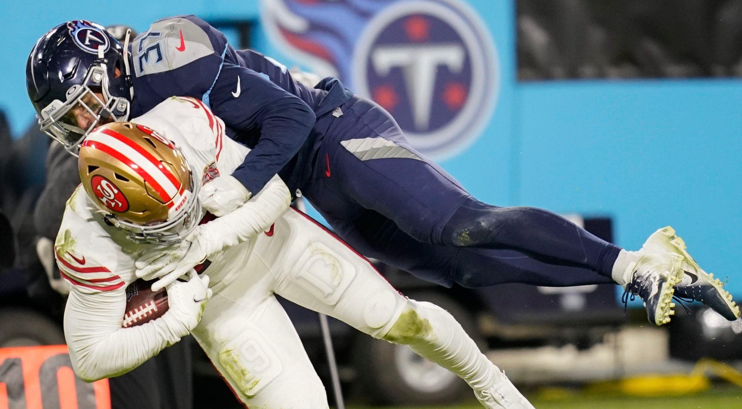 Tennessee Titans safety Amani Hooker (37) tackles San Francisco 49ers wide receiver Deebo Samuel (19) during the fourth quarter at Nissan Stadium Thursday, Dec. 23, 2021 in Nashville, Tenn. Titans 49ers 199