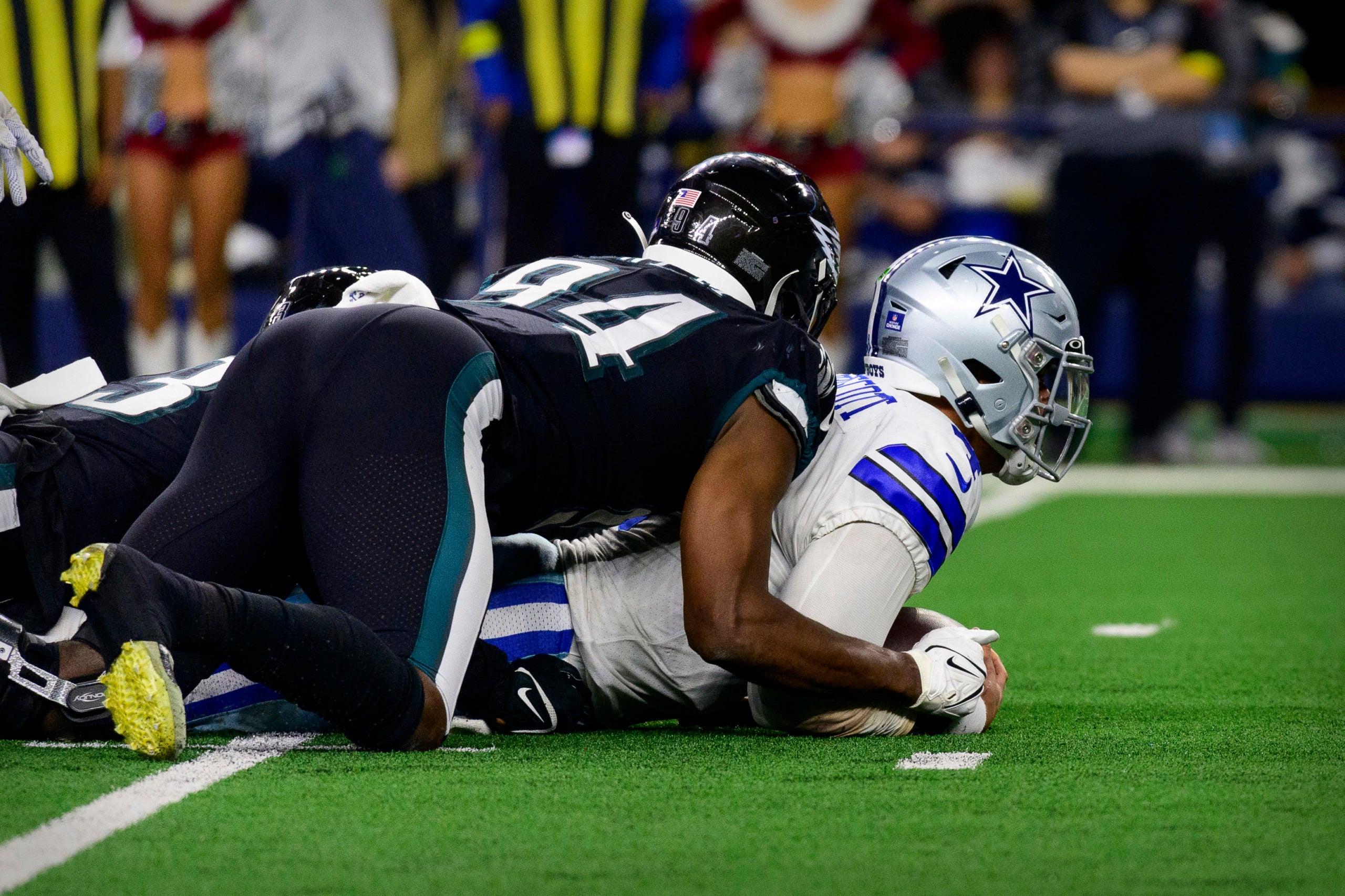 Dec 24, 2022; Arlington, Texas, USA; Dallas Cowboys quarterback Dak Prescott (4) is brought down by Philadelphia Eagles defensive end Josh Sweat (94) during the second half at AT&T Stadium. Mandatory Credit: Jerome Miron-USA TODAY Sports