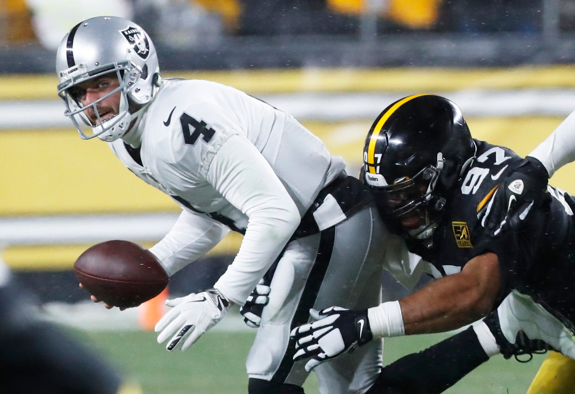 Dec 24, 2022; Pittsburgh, Pennsylvania, USA;  Las Vegas Raiders quarterback Derek Carr (4) is sacked by Pittsburgh Steelers defensive tackle Cameron Heyward (97) during the first quarter at Acrisure Stadium. Mandatory Credit: Charles LeClaire-USA TODAY Sports