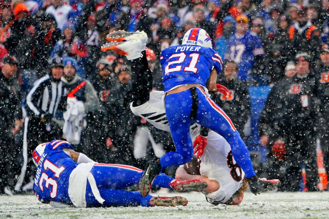 Jan 22, 2023; Orchard Park, New York, USA; Buffalo Bills safety Jordan Poyer (21) and safety Dean Marlowe (31) tackle Cincinnati Bengals tight end Hayden Hurst (88) during the second quarter of an AFC divisional round game at Highmark Stadium. Mandatory Credit: Gregory Fisher-USA TODAY Sports