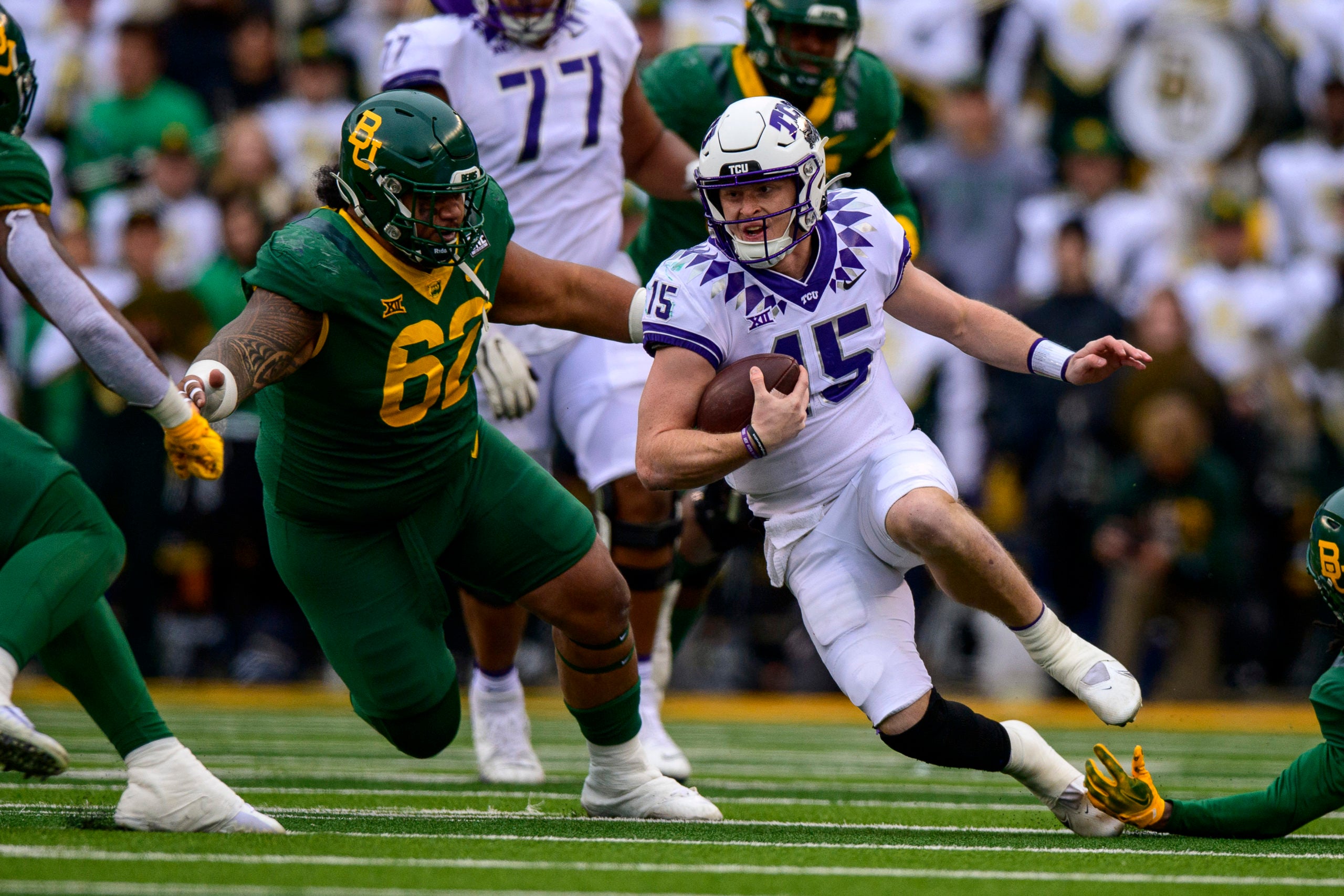 Nov 19, 2022; Waco, Texas, USA; TCU Horned Frogs quarterback Max Duggan (15) is brought down by Baylor Bears defensive lineman Siaki Ika (62) during the second half at McLane Stadium. Mandatory Credit: Jerome Miron-USA TODAY Sports