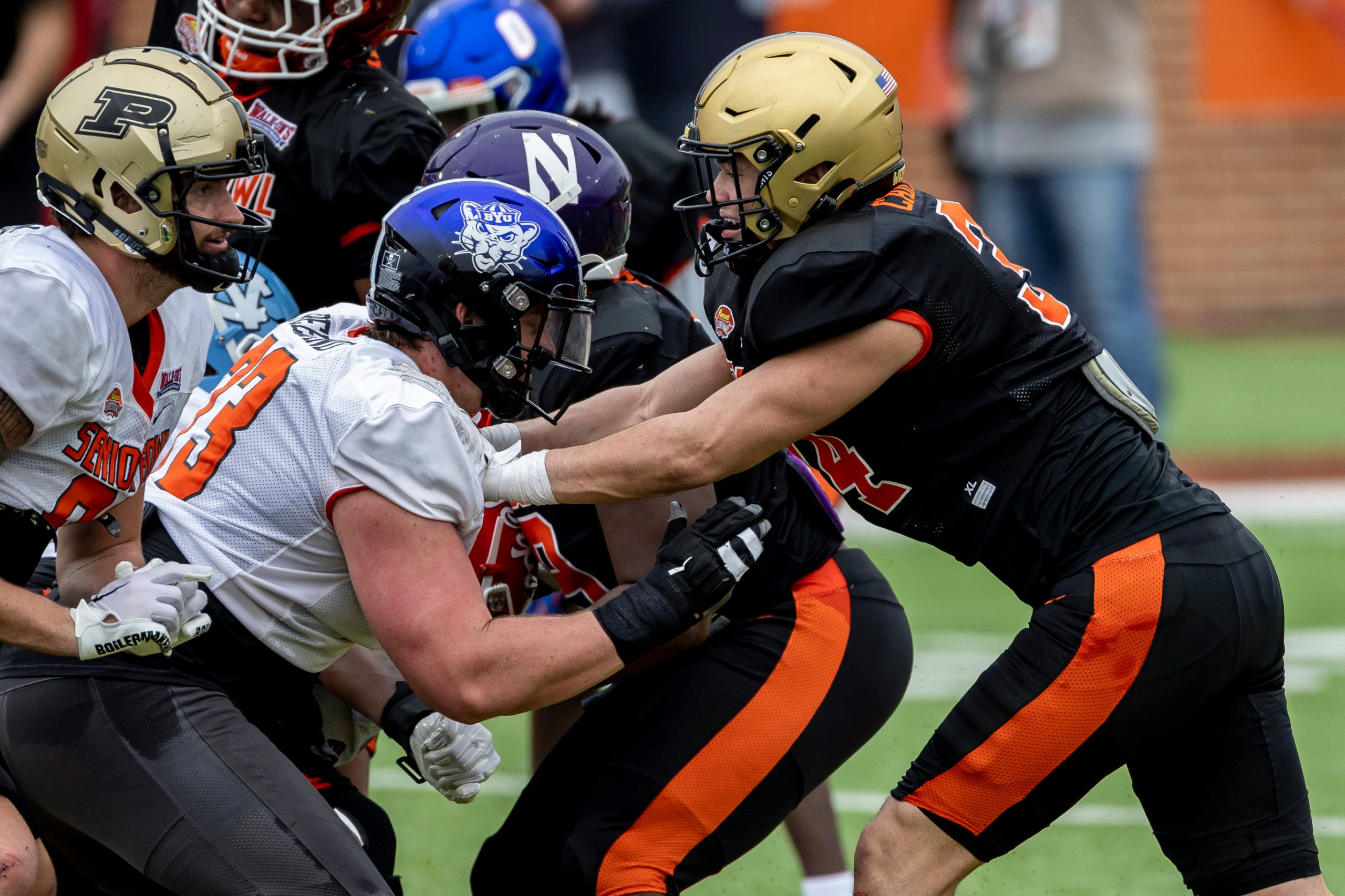 Feb 1, 2023; Mobile, AL, USA; National offensive lineman Blake Freeland of Brigham Young (73) works against National linebacker Andre Carter II of Army (34) during the second day of Senior Bowl week at Hancock Whitney Stadium in Mobile. Mandatory Credit: Vasha Hunt-USA TODAY Sports ***National tight end Payne Durham of Purdue (87) is seen at left***