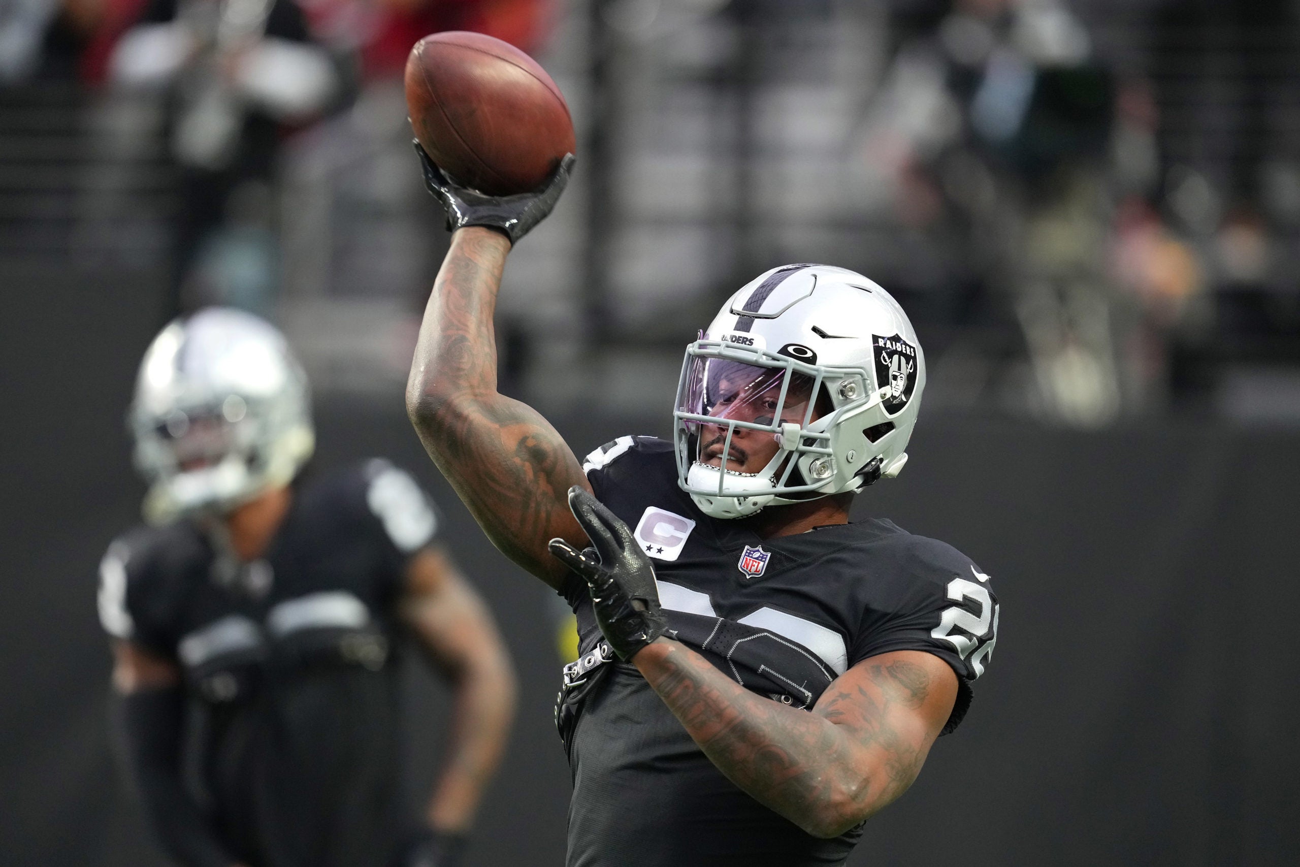 Josh Jacobs tosses the ball pregame