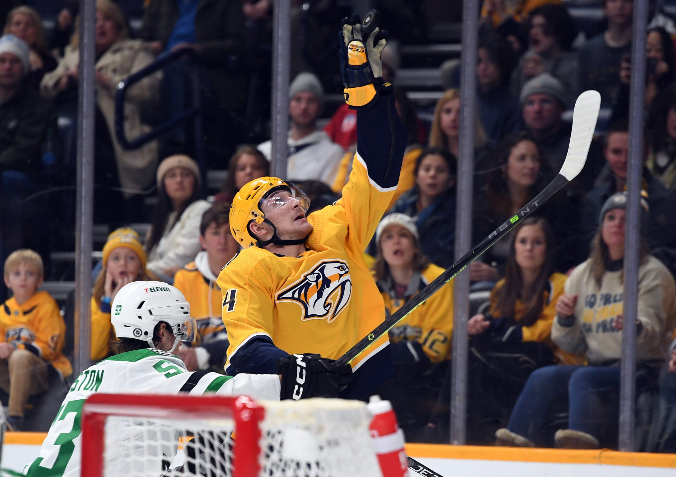 Dec 27, 2022; Nashville, Tennessee, USA; Nashville Predators left wing Tanner Jeannot (84) plays the puck out of the air against Dallas Stars center Wyatt Johnston (53) during the third period at Bridgestone Arena. Mandatory Credit: Christopher Hanewinckel-USA TODAY Sports