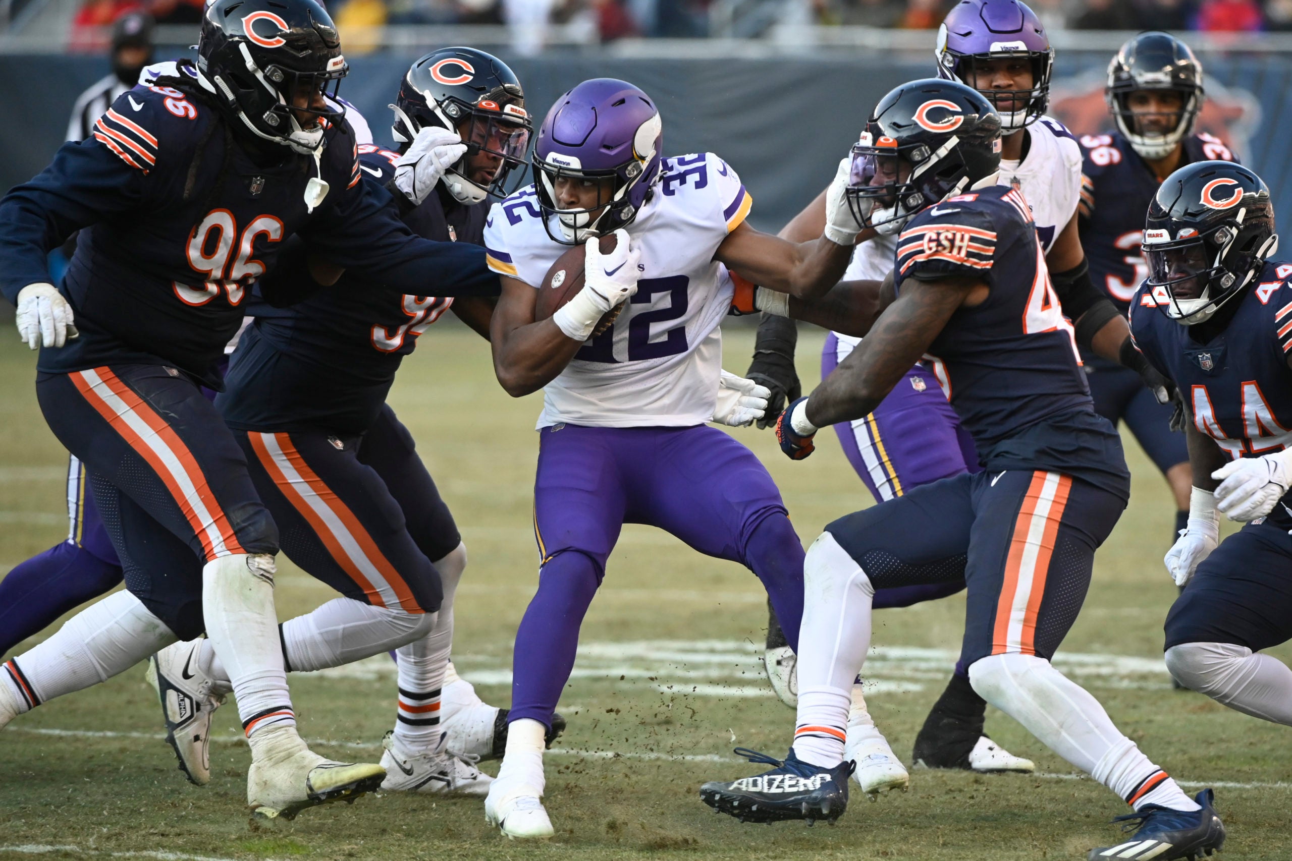 Jan 8, 2023; Chicago, Illinois, USA;  Minnesota Vikings running back Ty Chandler (32) is tackled by Chicago Bears players during the second half at Soldier Field. Mandatory Credit: Matt Marton-USA TODAY Sports
