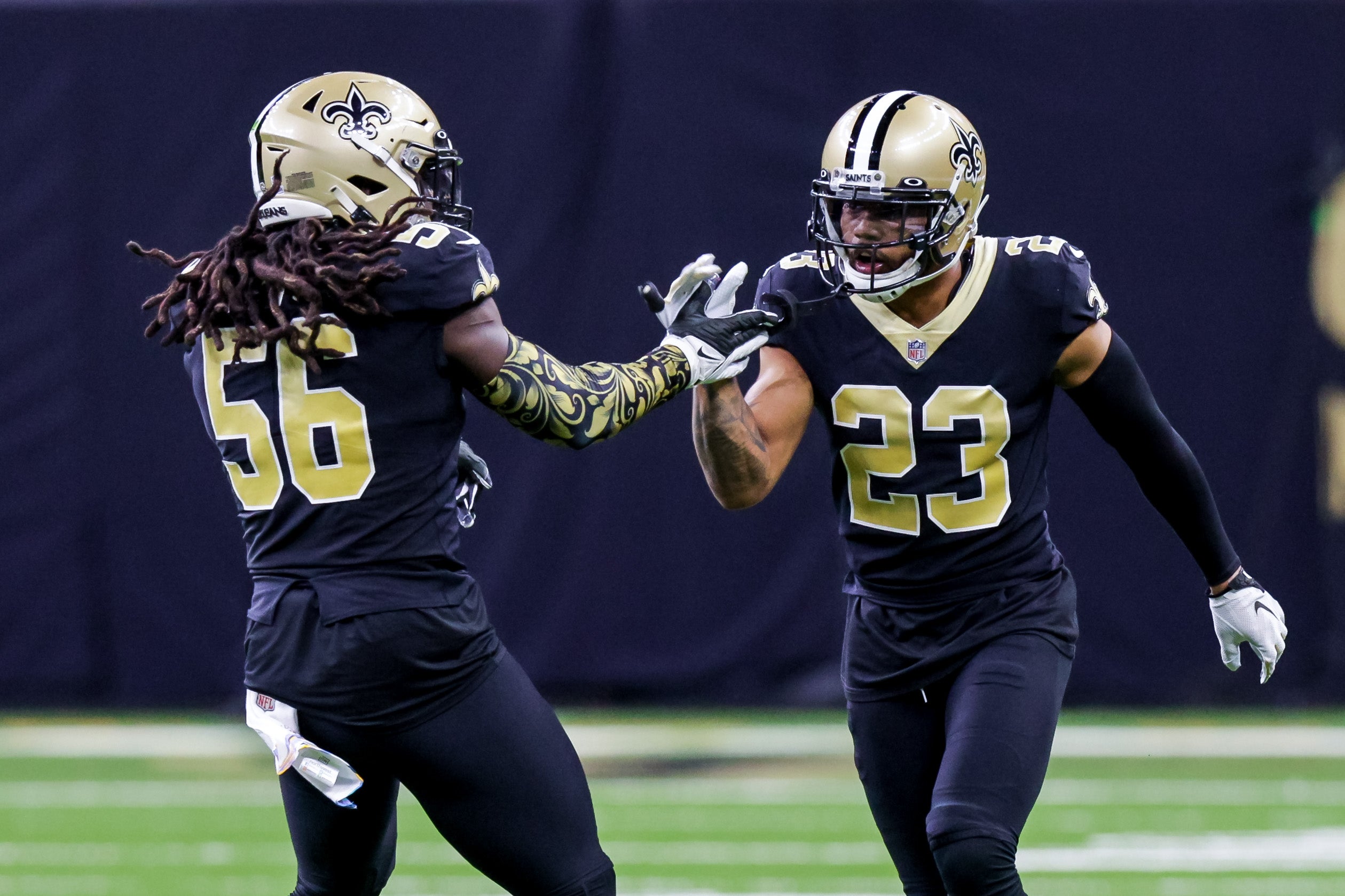 Oct 9, 2022; New Orleans, Louisiana, USA; New Orleans Saints linebacker Demario Davis (56) and cornerback Marshon Lattimore (23) react after a play against the Seattle Seahawks during the second half at Caesars Superdome. Mandatory Credit: Stephen Lew-USA TODAY Sports