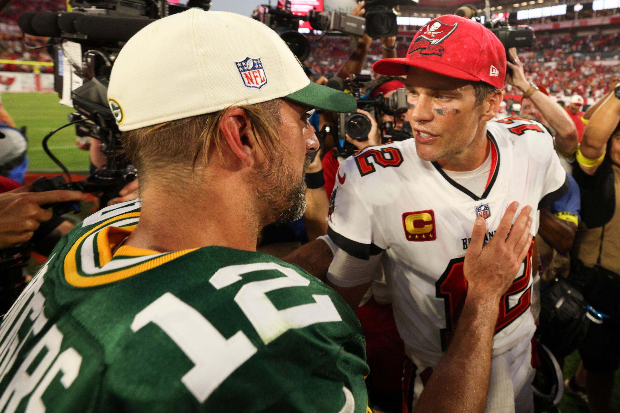 Sep 25, 2022; Tampa, Florida, USA;  Tampa Bay Buccaneers quarterback Tom Brady (12) and Green Bay Packers quarterback Aaron Rodgers (12) greet each other after the Green Bay Packers beat the Tampa Bay Buccaneers at Raymond James Stadium. Mandatory Credit: Nathan Ray Seebeck-USA TODAY Sports
