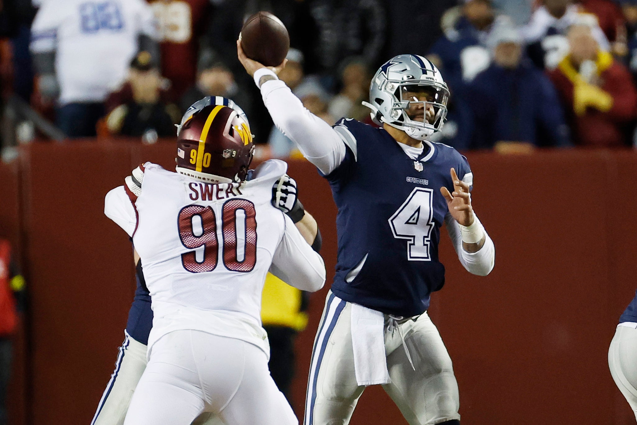 Jan 8, 2023; Landover, Maryland, USA; Dallas Cowboys quarterback Dak Prescott (4) passes the ball as Washington Commanders defensive end Montez Sweat (90) defends during the second quarter at FedExField. Mandatory Credit: Geoff Burke-USA TODAY Sports