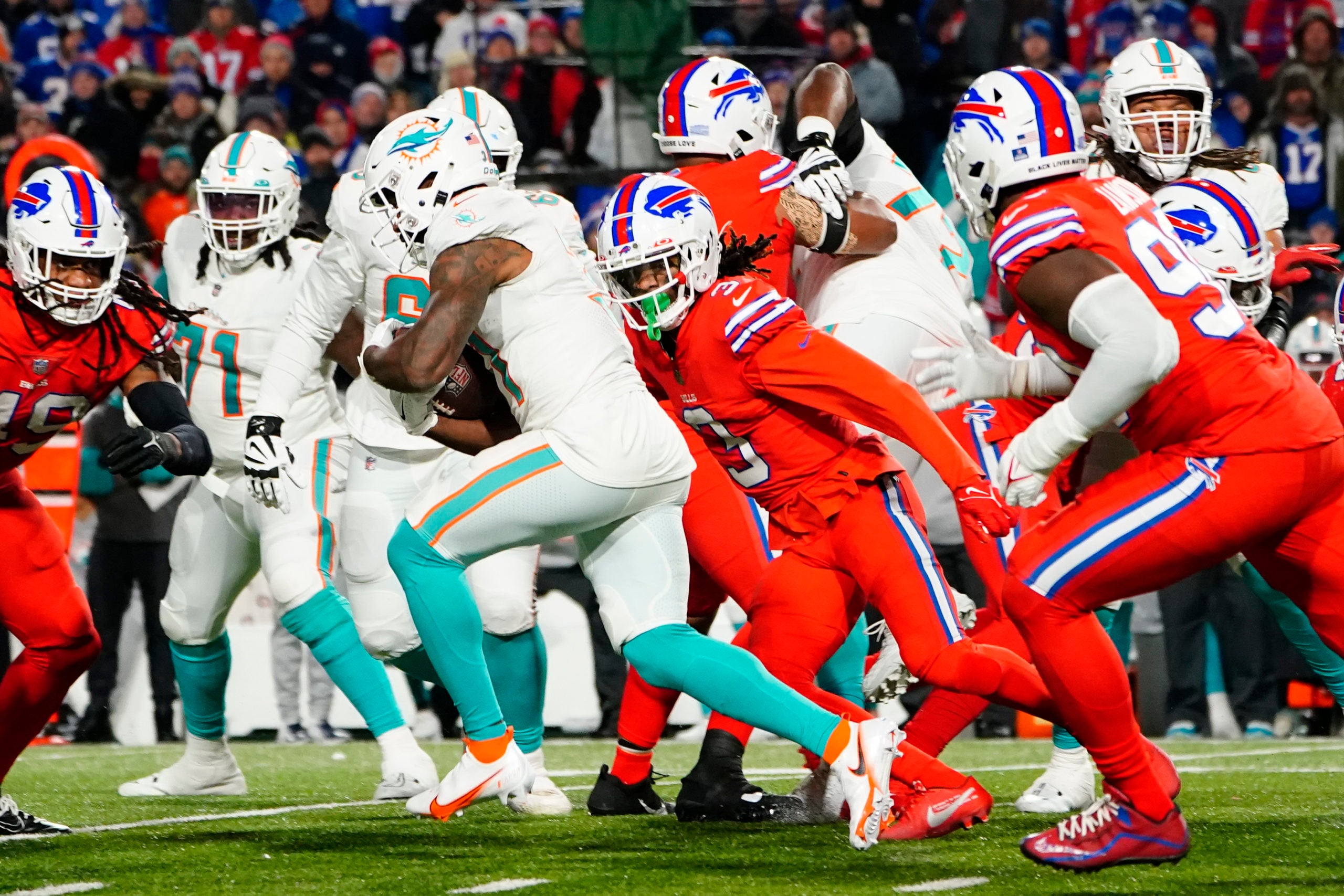 Dec 17, 2022; Orchard Park, New York, USA; Miami Dolphins running back Raheem Mostert (31) runs with the ball against Buffalo Bills safety Damar Hamlin (3) during the second half at Highmark Stadium. Mandatory Credit: Gregory Fisher-USA TODAY Sports