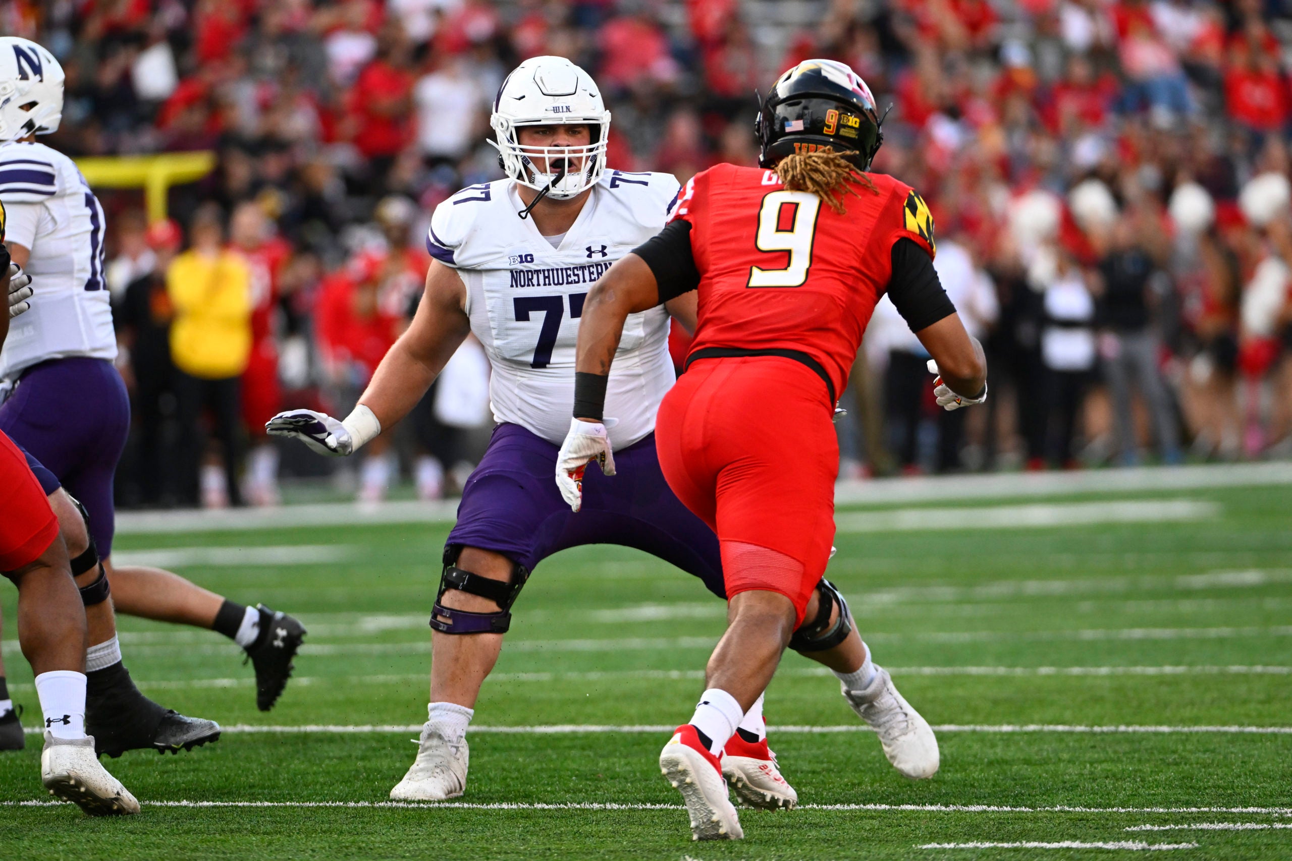 Oct 22, 2022; College Park, Maryland, USA; Northwestern Wildcats offensive lineman Peter Skoronski (77) prepares to block Maryland Terrapins linebacker Fa'Najae Gotay (9) during the first half at SECU Stadium. Mandatory Credit: Brad Mills-USA TODAY Sports