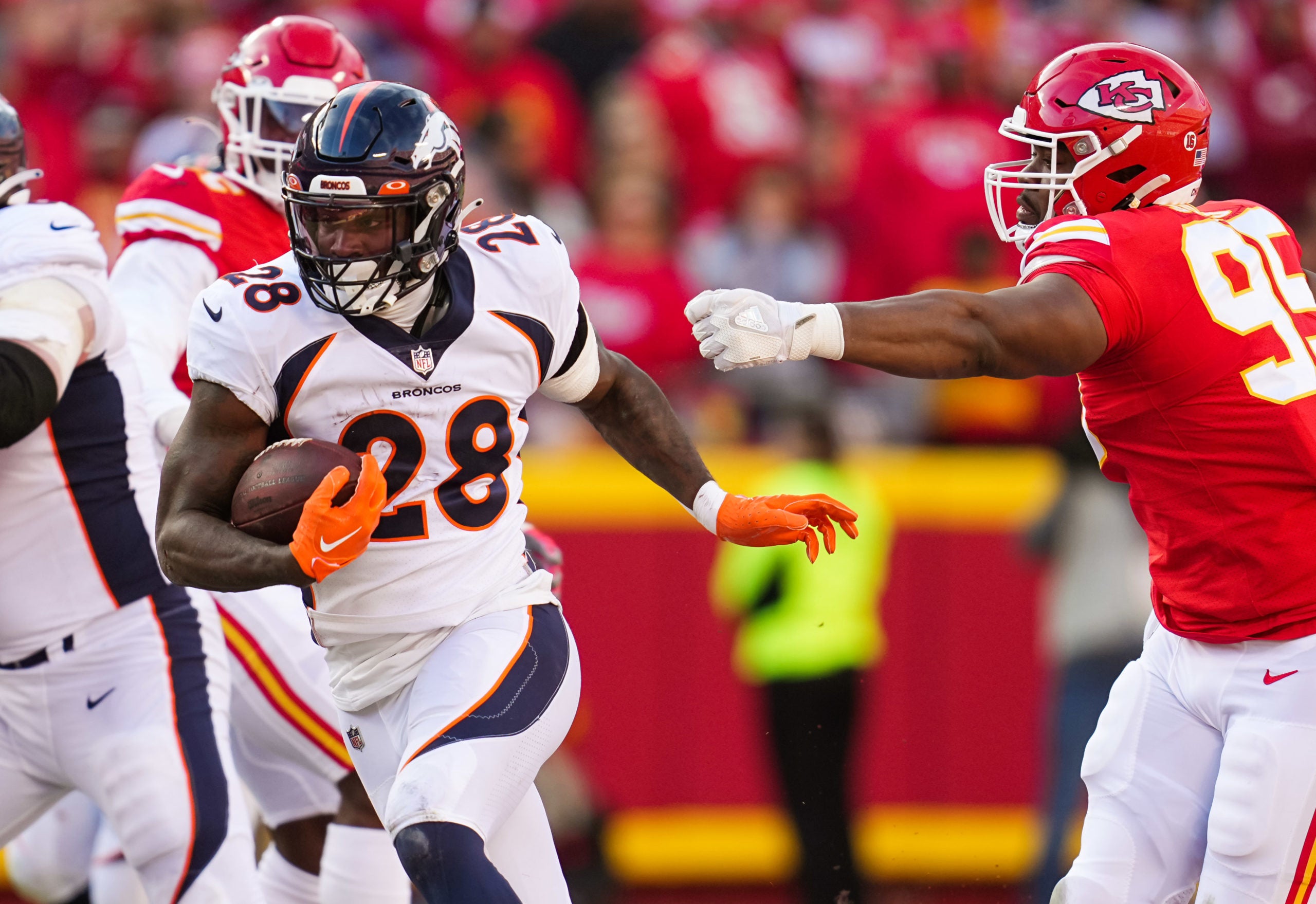 Jan 1, 2023; Kansas City, Missouri, USA; Denver Broncos running back Latavius Murray (28) runs the ball past Kansas City Chiefs defensive tackle Chris Jones (95) during the second half at GEHA Field at Arrowhead Stadium. Mandatory Credit: Jay Biggerstaff-USA TODAY Sports
