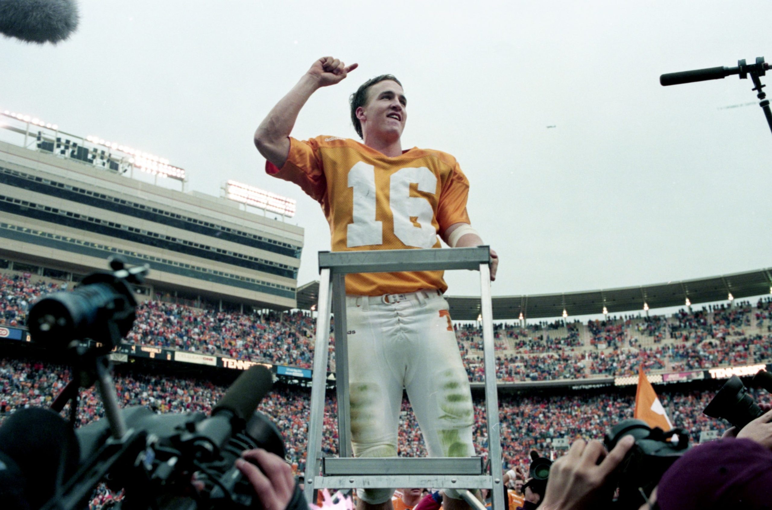 Tennessee quarterback and "maestro" Peyton Manning leads the Vols' Pride of the Southland Band in a rendition of "Rocky Top" after the No. 3 ranked Volunteers closed out Vanderbilt 17-10 at Neyland Stadium in Knoxville Nov. 29, 1997. Tennessee earned its first ever trip to the SEC Championship game to faced Auburn.