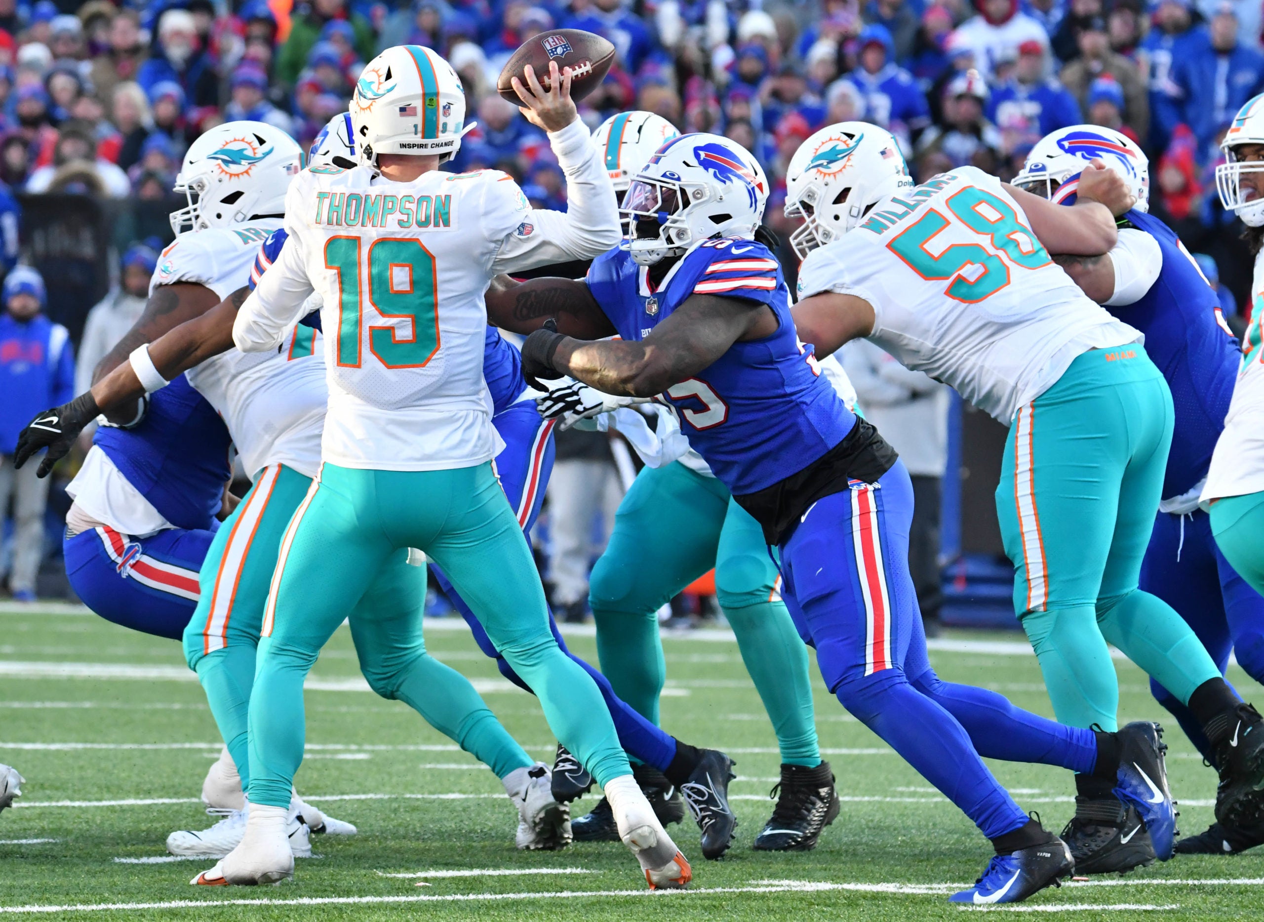 Jan 15, 2023; Orchard Park, NY, USA; Miami Dolphins quarterback Skylar Thompson (19) is pressured by Buffalo Bills defensive end Boogie Basham (55) during the second half in a NFL wild card game at Highmark Stadium. Mandatory Credit: Mark Konezny-USA TODAY Sports