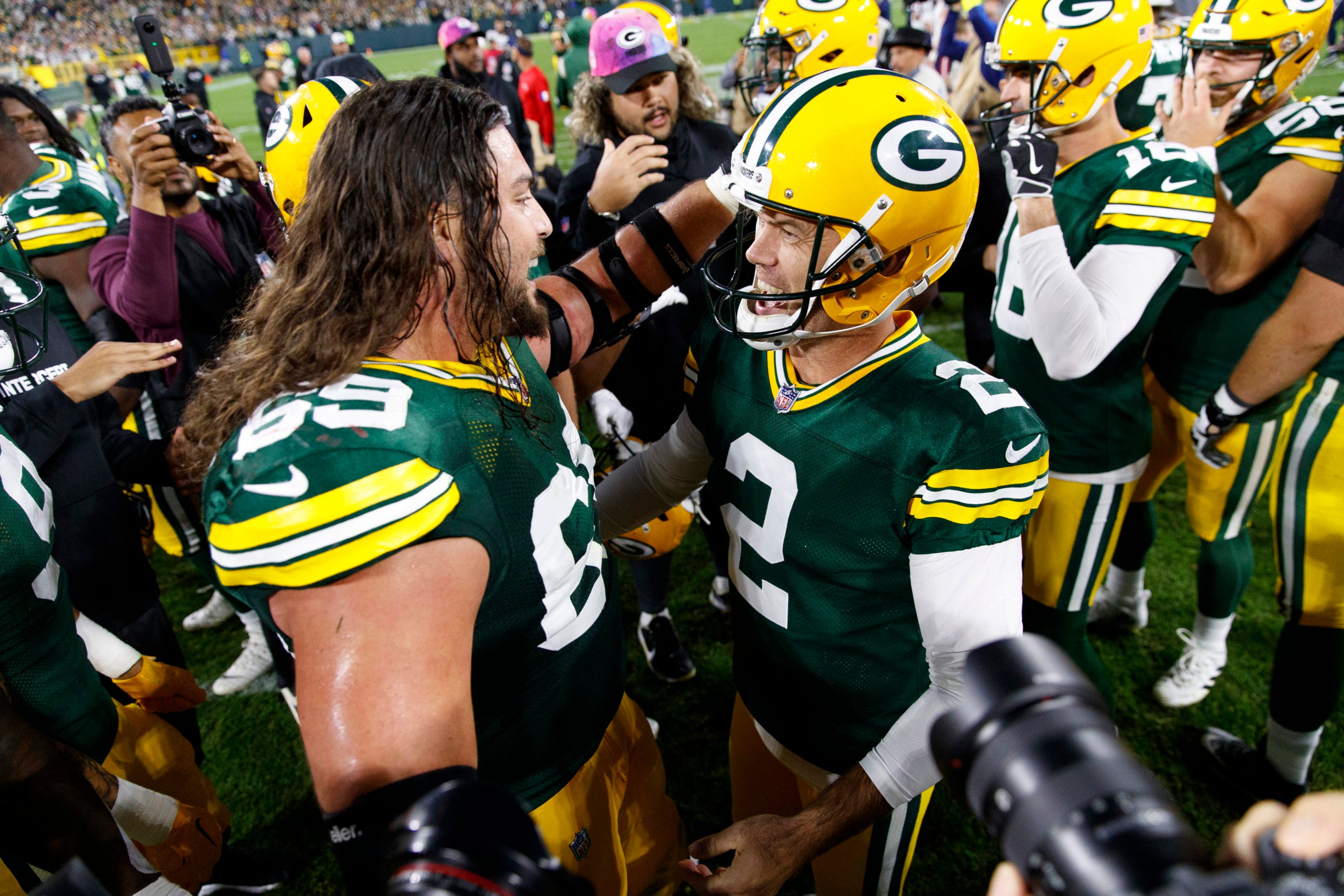 Oct 2, 2022; Green Bay, Wisconsin, USA;  Green Bay Packers kicker Mason Crosby (2) is congratulated by offensive tackle David Bakhtiari (69) after kicking the game winning field goal during overtime against the New England Patriots at Lambeau Field. Mandatory Credit: Jeff Hanisch-USA TODAY Sports