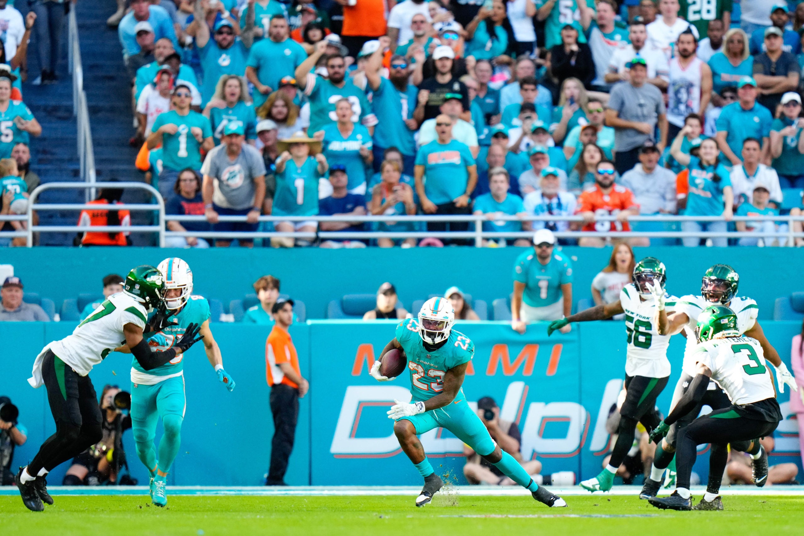 Jan 8, 2023; Miami Gardens, Florida, USA; Miami Dolphins running back Jeff Wilson Jr. (23) runs the ball against the New York Jets during the second half at Hard Rock Stadium. Mandatory Credit: Rich Storry-USA TODAY Sports