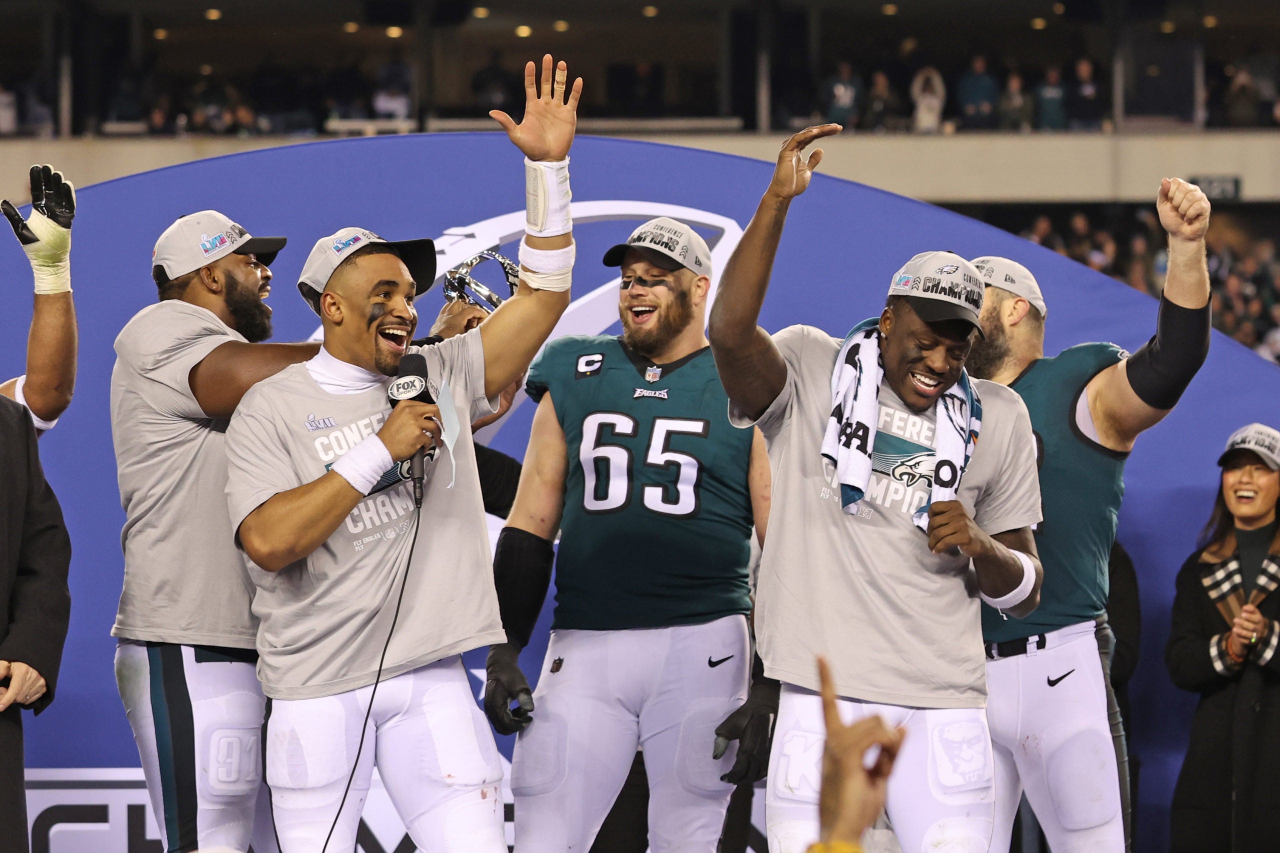 Jan 29, 2023; Philadelphia, Pennsylvania, USA;  Philadelphia Eagles quarterback Jalen Hurts (1) celebrates with offensive tackle Lane Johnson (65) and wide receiver A.J. Brown (11) during the NFC Championship trophy presentation after win against the San Francisco 49ers in the NFC Championship game at Lincoln Financial Field. Mandatory Credit: Bill Streicher-USA TODAY Sports