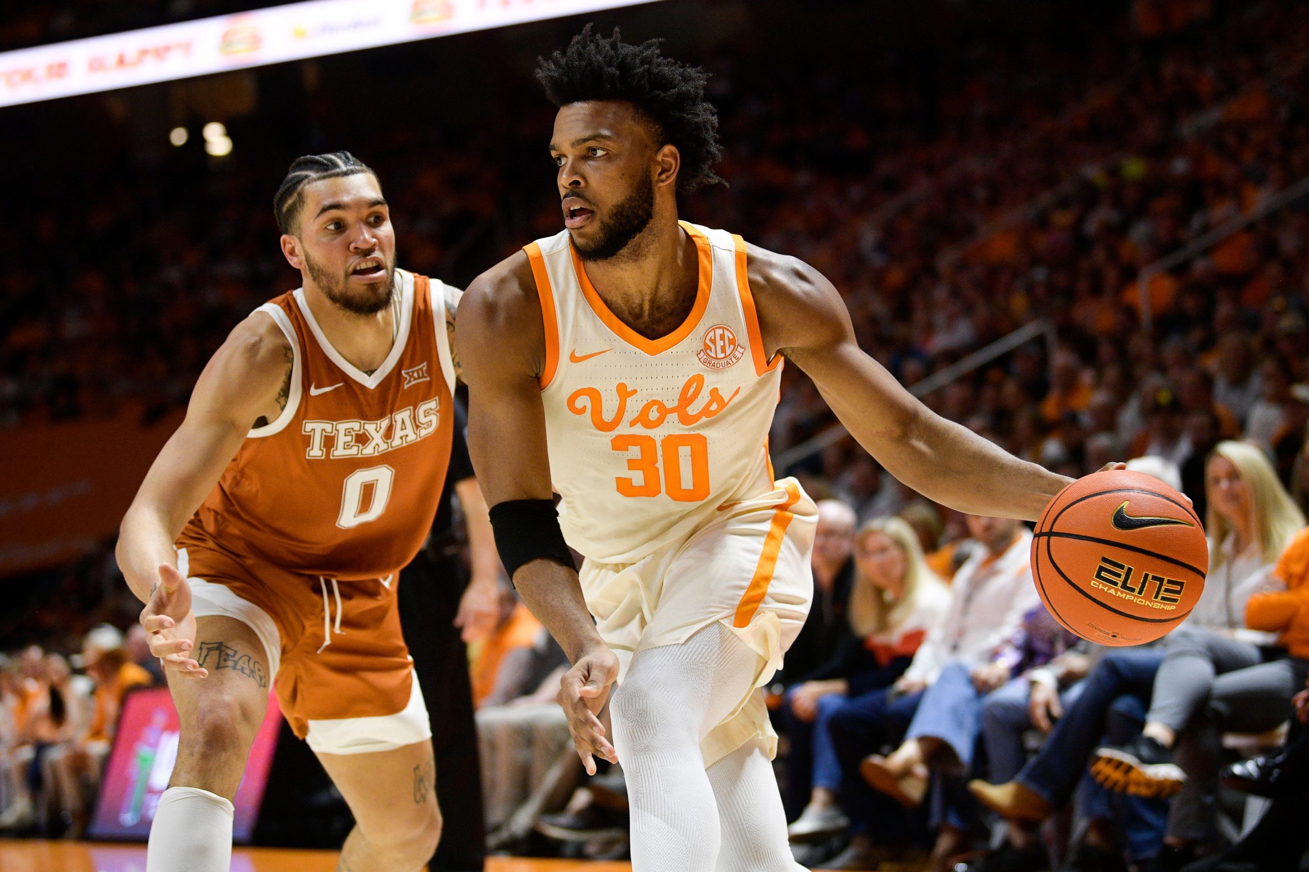Tennessee guard Josiah-Jordan James (30) passes the ball around Texas forward Timmy Allen (0) during a game between Tennessee and Texas at Thompson-Boling Arena in Knoxville, Tenn., on Saturday, Jan. 28, 2023. Kns Ut Basketball Vs Texas
