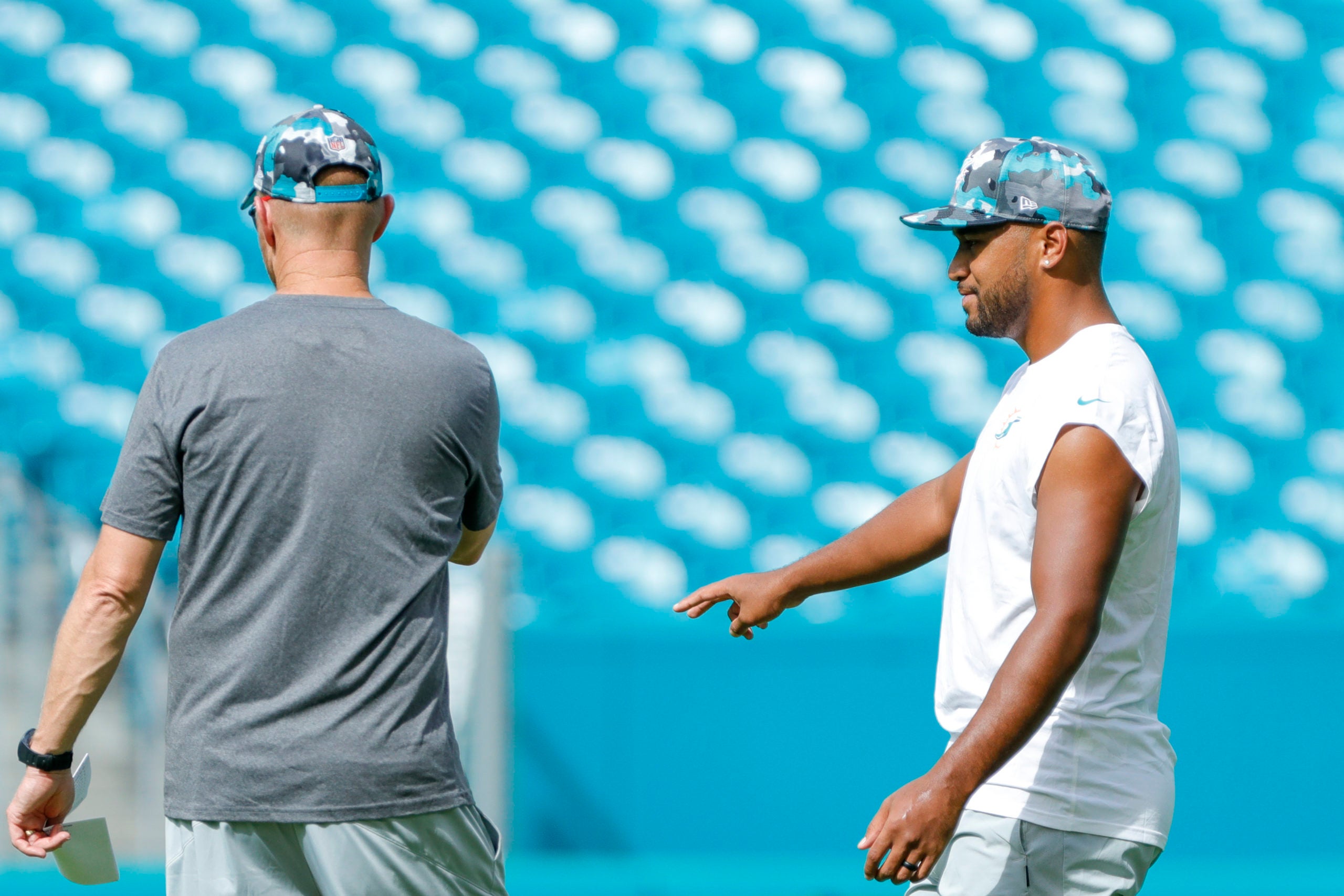 Aug 27, 2022; Miami Gardens, Florida, USA; Miami Dolphins quarterback Tua Tagovailoa (1) talks to quarterback and passing coordinator Darrell Bevell prior to the game against the Philadelphia Eagles at Hard Rock Stadium. Mandatory Credit: Sam Navarro-USA TODAY Sports