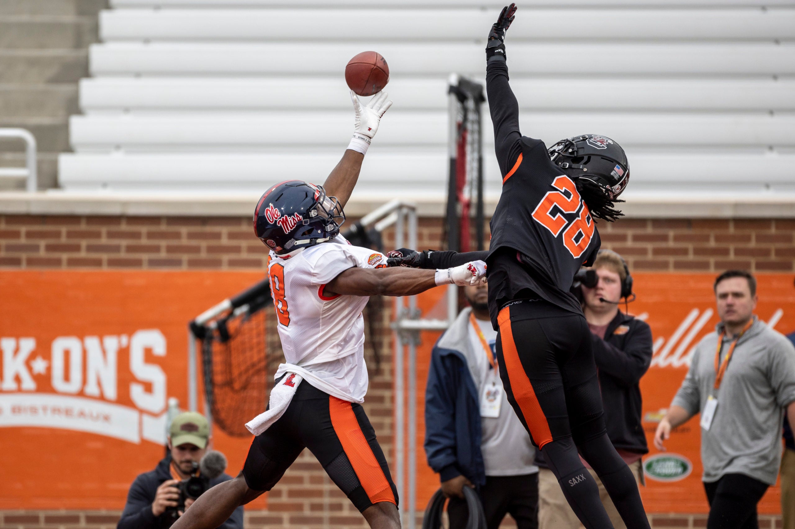 Feb 2, 2023; Mobile, AL, USA; American wide receiver Jonathan Mingo of Ole Miss (18) and American defensive back Darius Rush of South Carolina (28) battle for a pass during the third day of Senior Bowl week at Hancock Whitney Stadium in Mobile. Mandatory Credit: Vasha Hunt-USA TODAY Sports