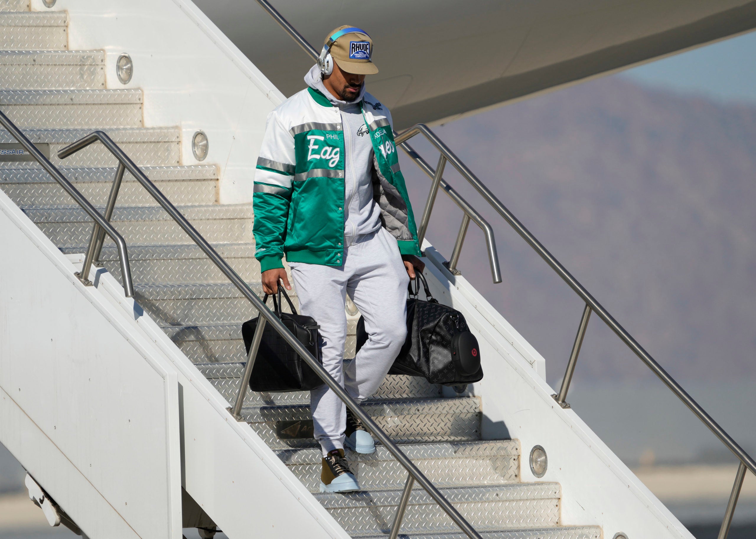 Jalen Hurts walking off a plane in Arizona.