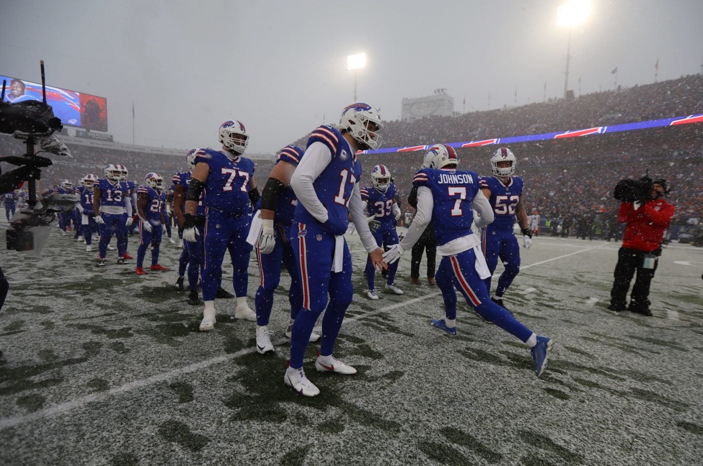 Bills quarterback Josh Allen high fives teammates as they are introduced before the game against the Cincinnati Bengals  in Orchard Park on Jan. 22. Ty 012223 Bills Introduce Players