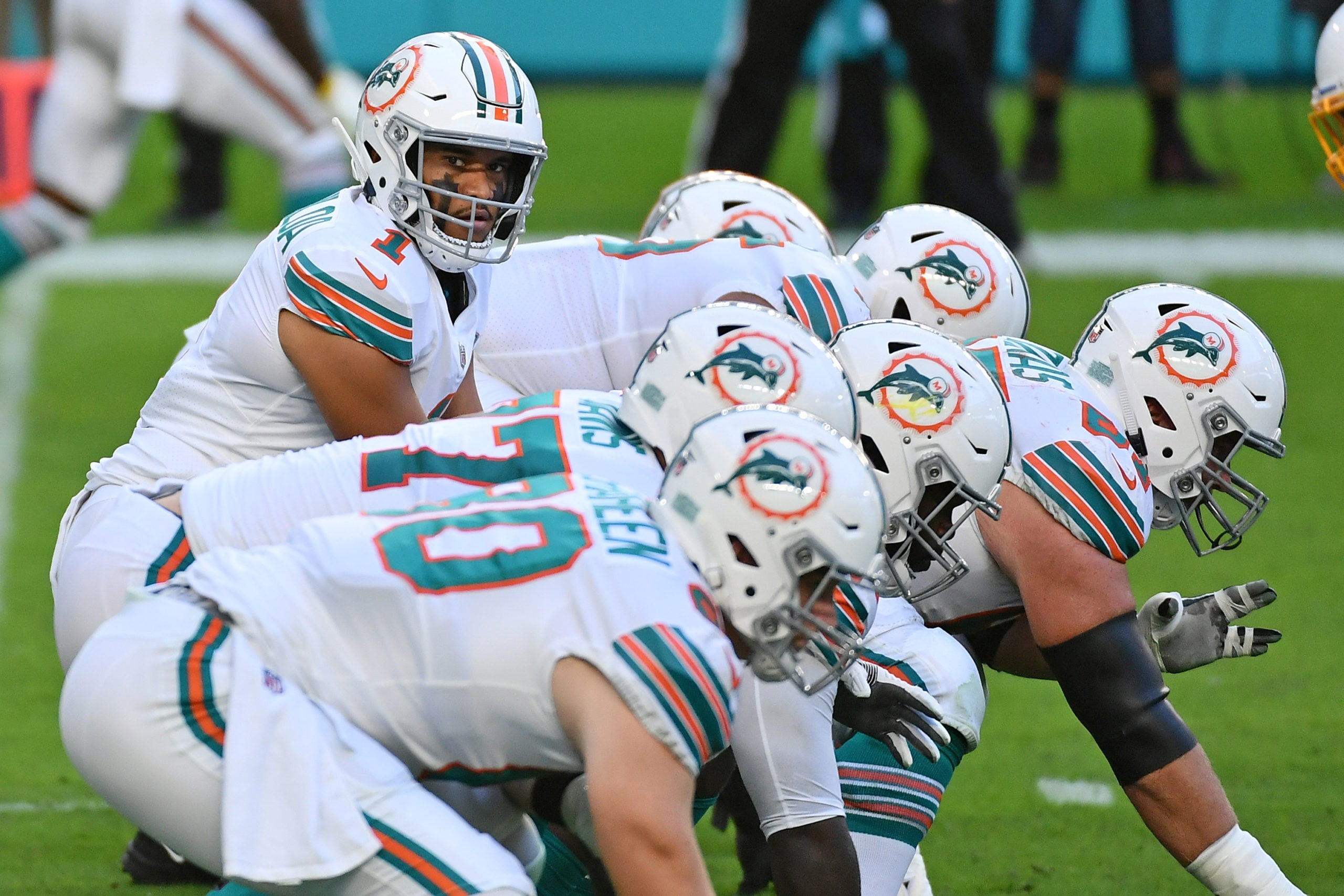 Nov 15, 2020; Miami Gardens, Florida, USA; Miami Dolphins quarterback Tua Tagovailoa (1) looks over the offensive line during the first half against the Los Angeles Chargers at Hard Rock Stadium. Mandatory Credit: Jasen Vinlove-USA TODAY Sports